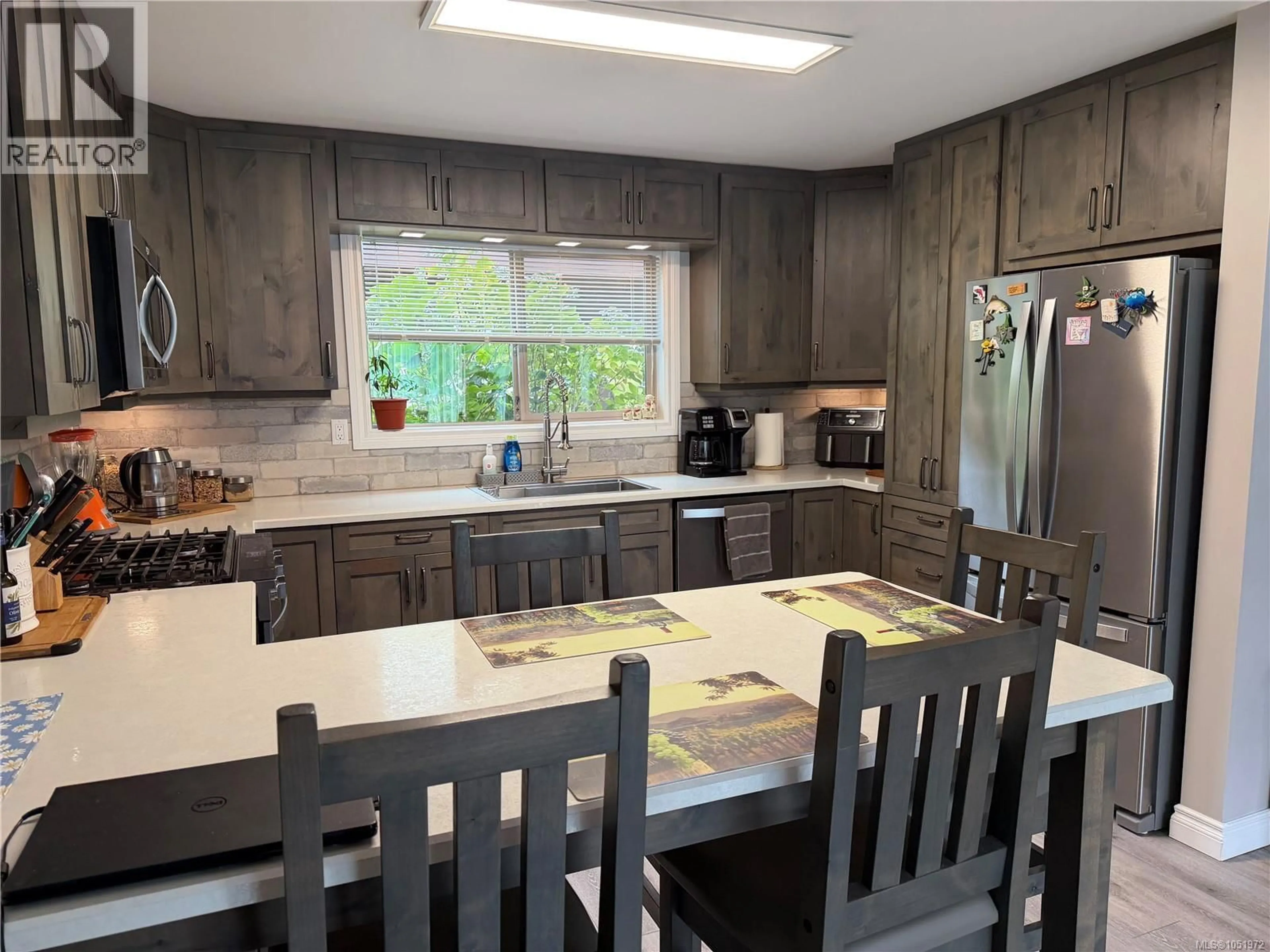 Open concept kitchen, wood/laminate floor for 202 HAIDA AVENUE, Port Alice British Columbia V0N2N0