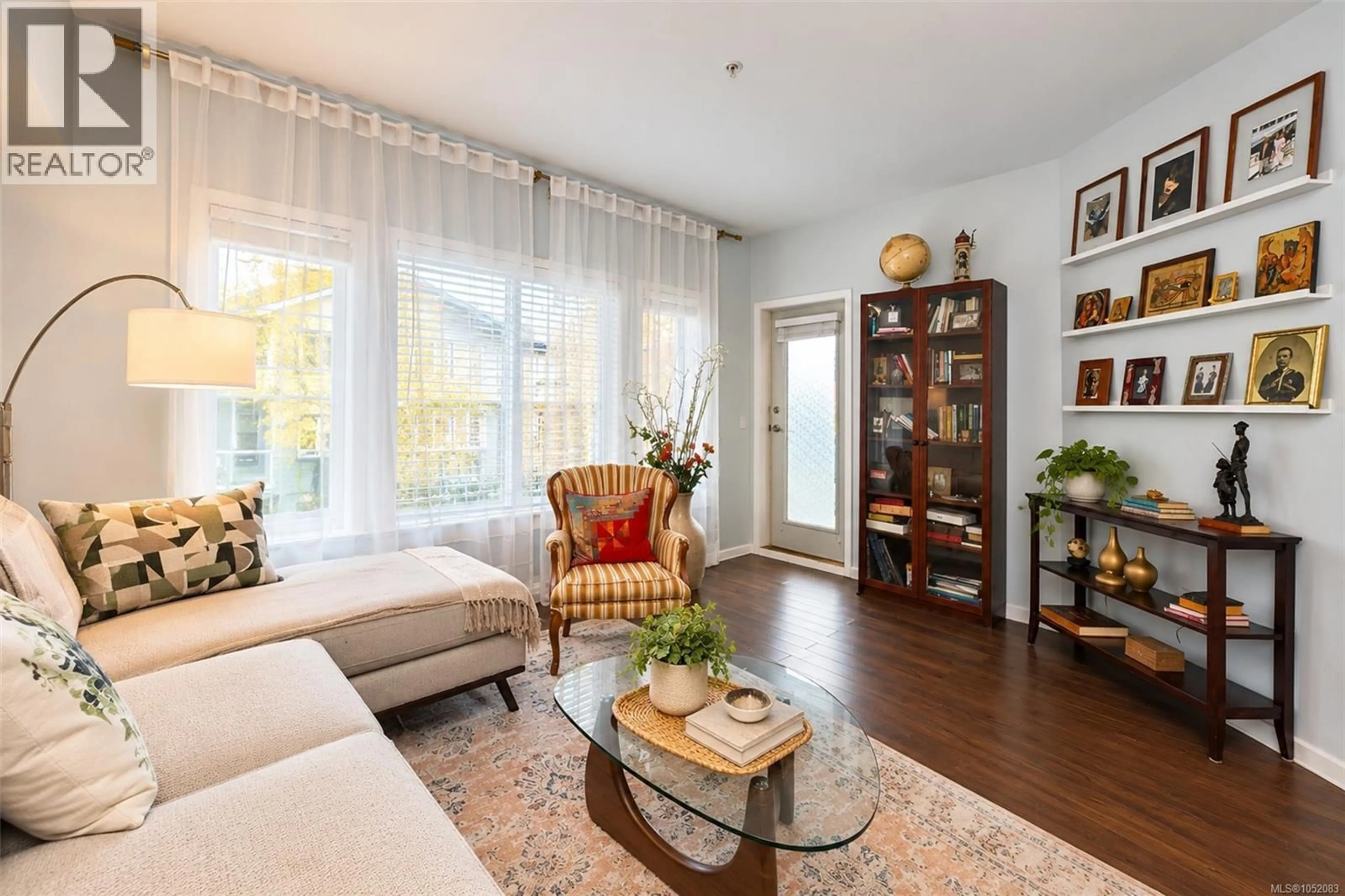 Living room with furniture, wood/laminate floor for 104 - 360 GOLDSTREAM AVENUE, Colwood British Columbia V9B2W3
