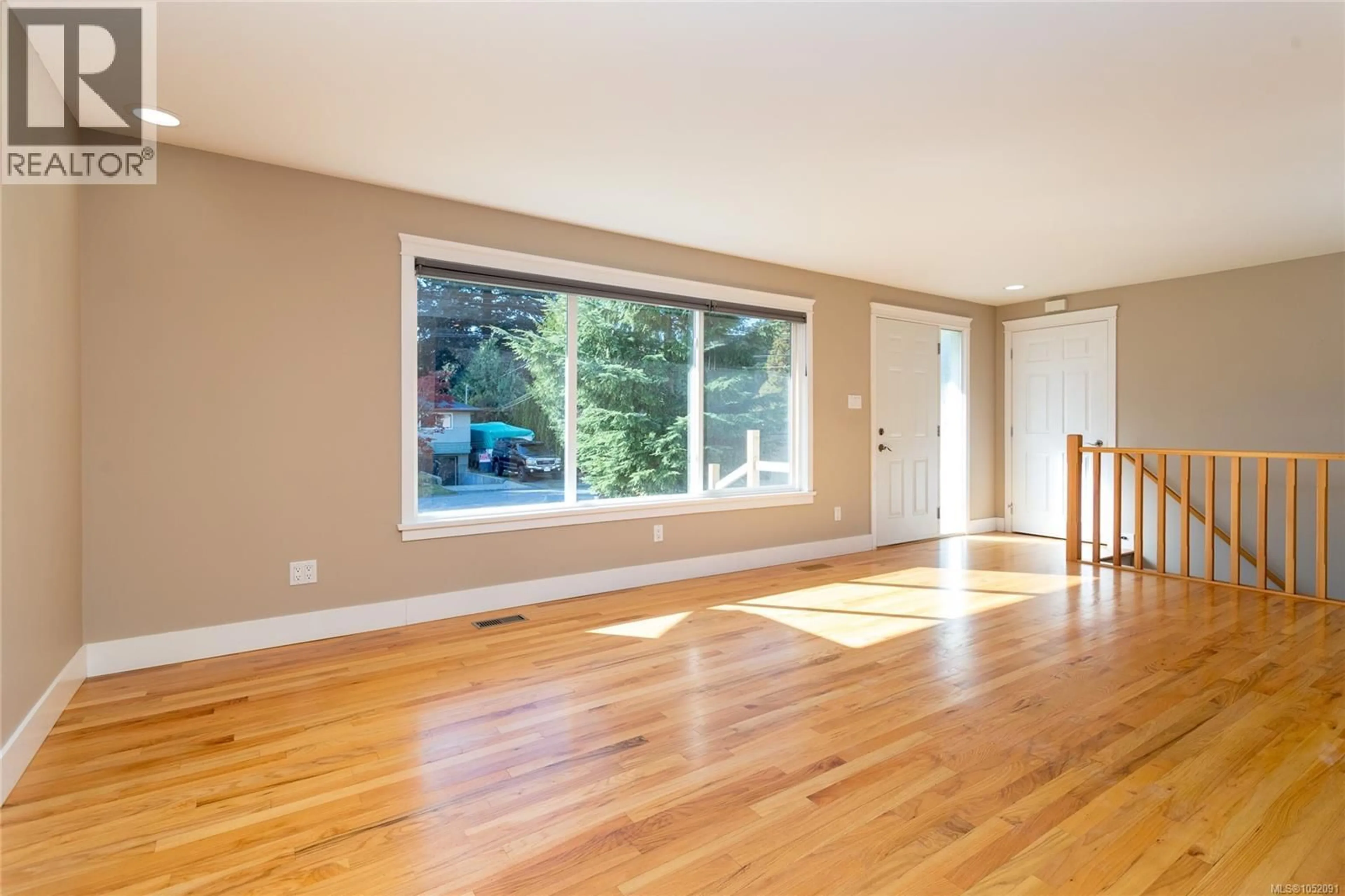 Living room with furniture, wood/laminate floor for 590 RIDLEY DRIVE, Colwood British Columbia V9C1K4