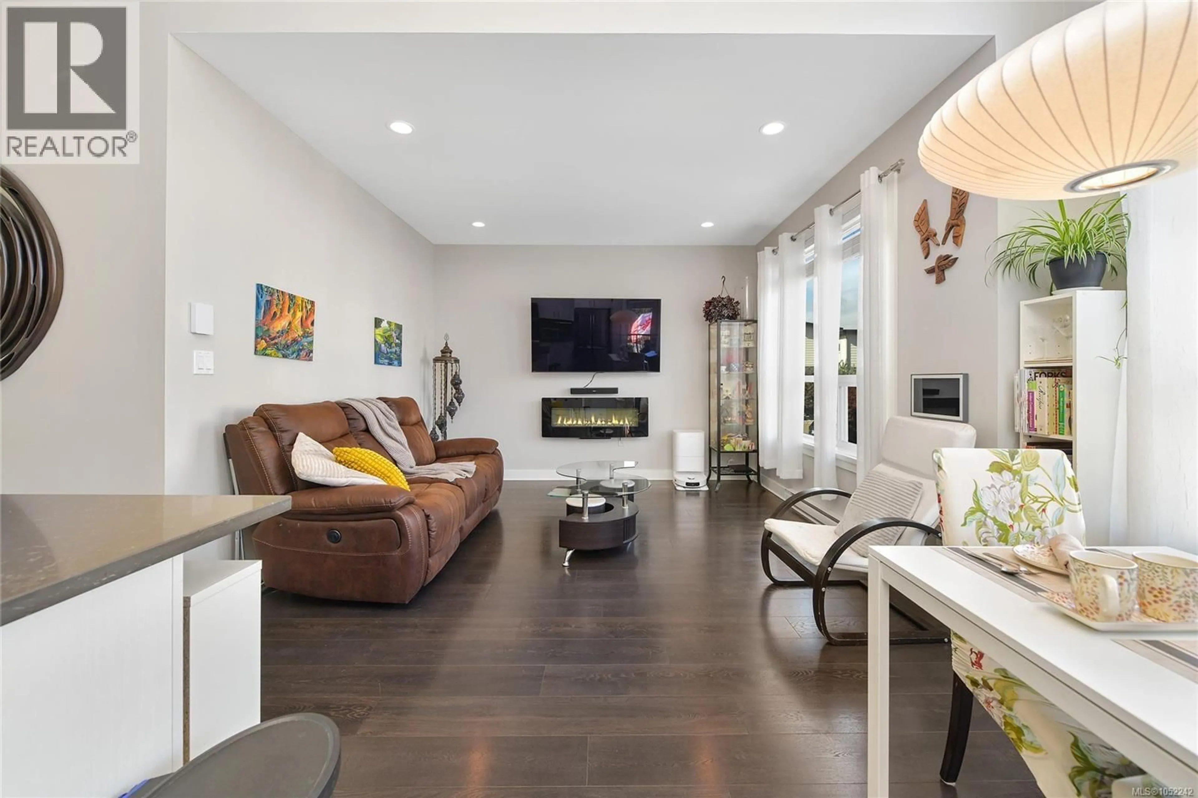 Living room with furniture, wood/laminate floor for 1005 BOEING CLOSE, Langford British Columbia V9B0R2