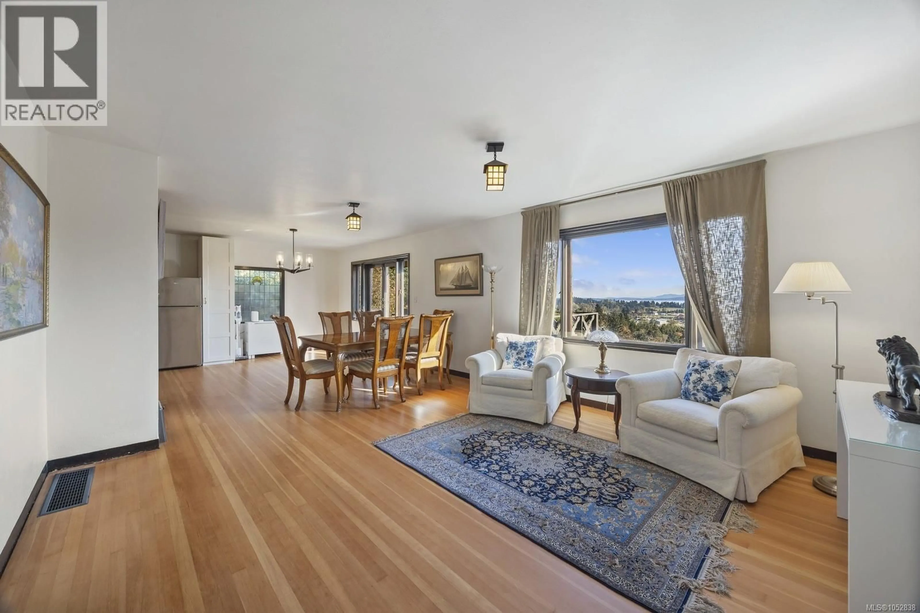 Living room with furniture, wood/laminate floor for 5904 OLD EAST ROAD, Saanich British Columbia V8Y1V6