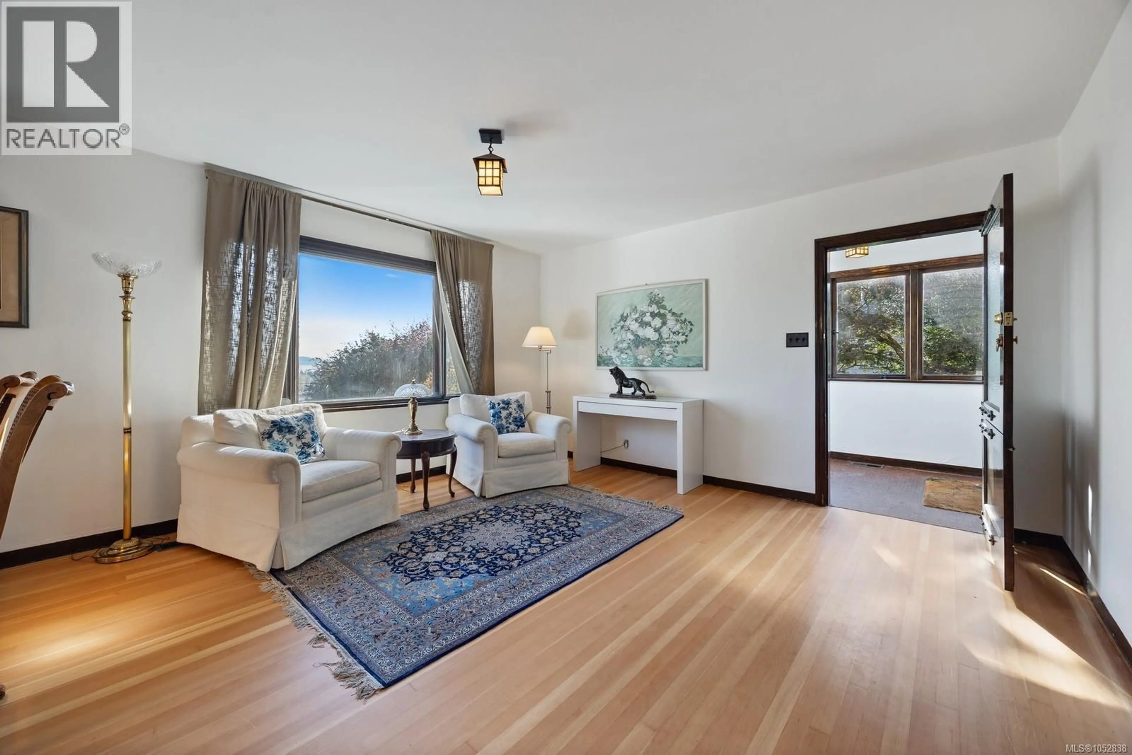 Living room with furniture, wood/laminate floor for 5904 OLD EAST ROAD, Saanich British Columbia V8Y1V6