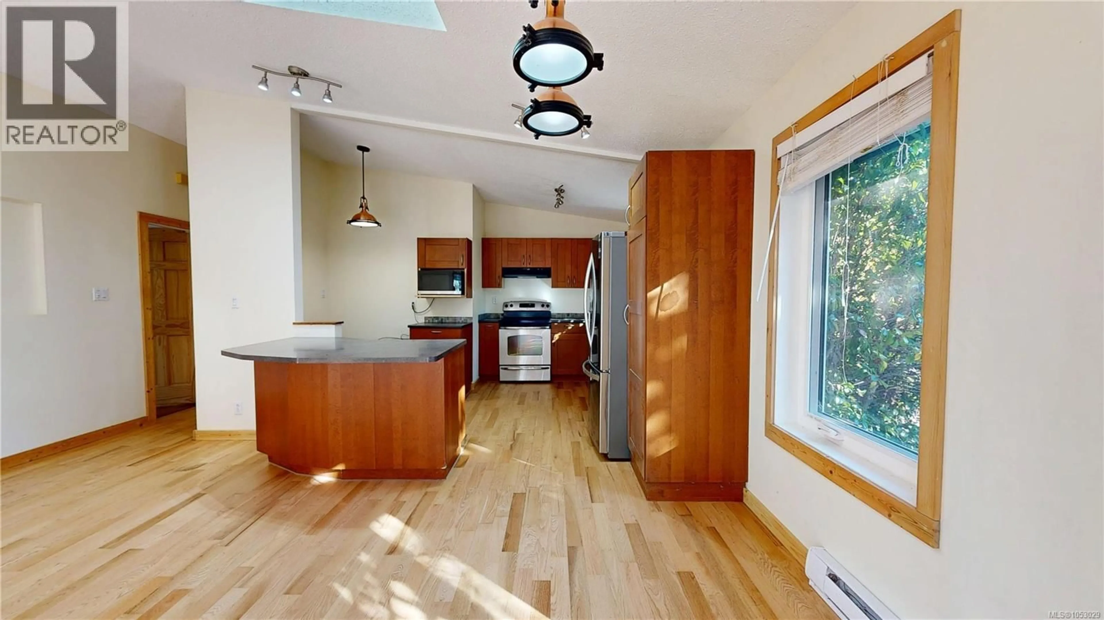 Open concept kitchen, wood/laminate floor for 1320 NORTH ROAD, Gabriola Island British Columbia V0R1X5
