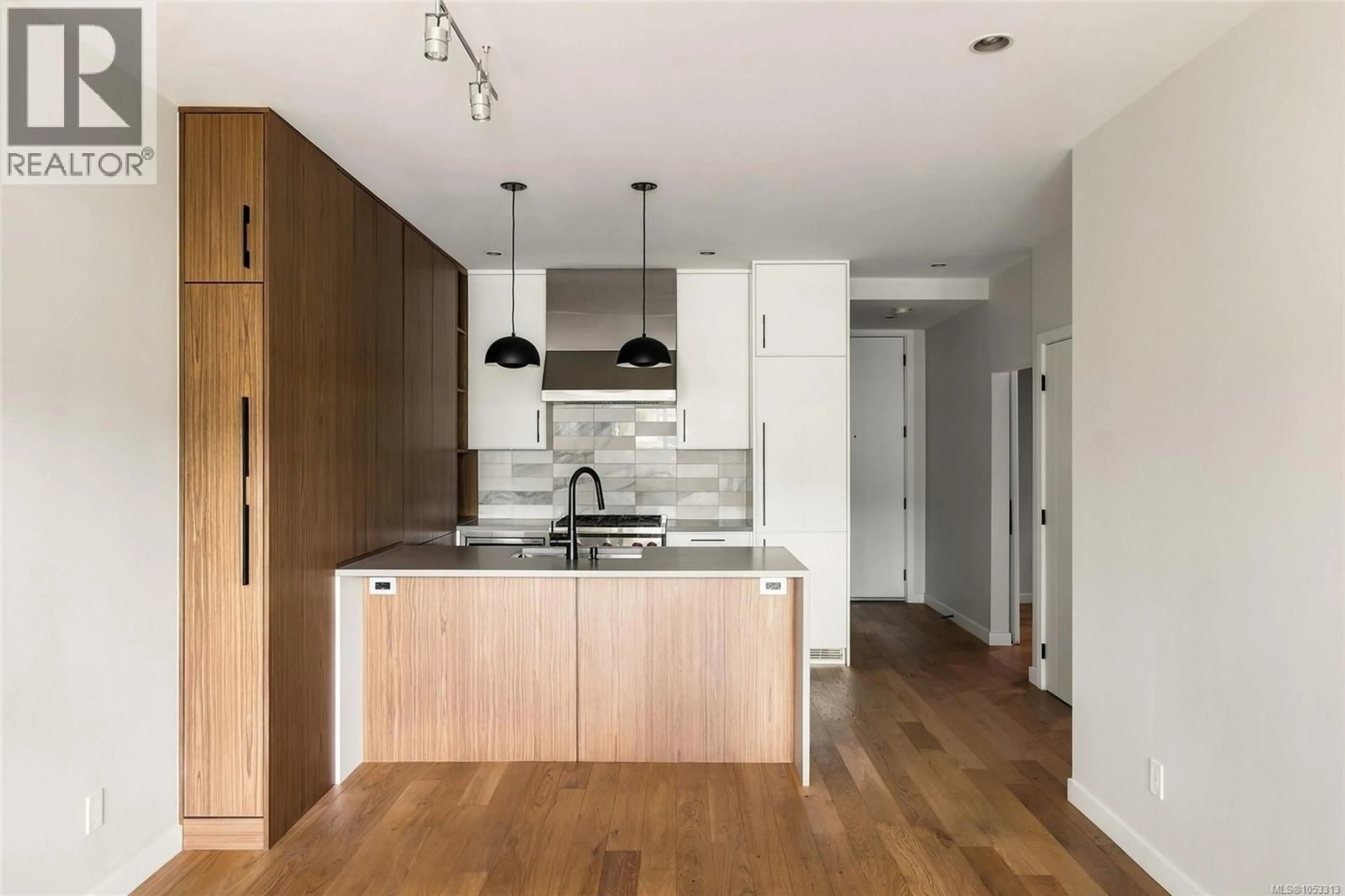 Open concept kitchen, wood/laminate floor for 207 - 1018 PENTRELEW PLACE, Victoria British Columbia V8V4J4