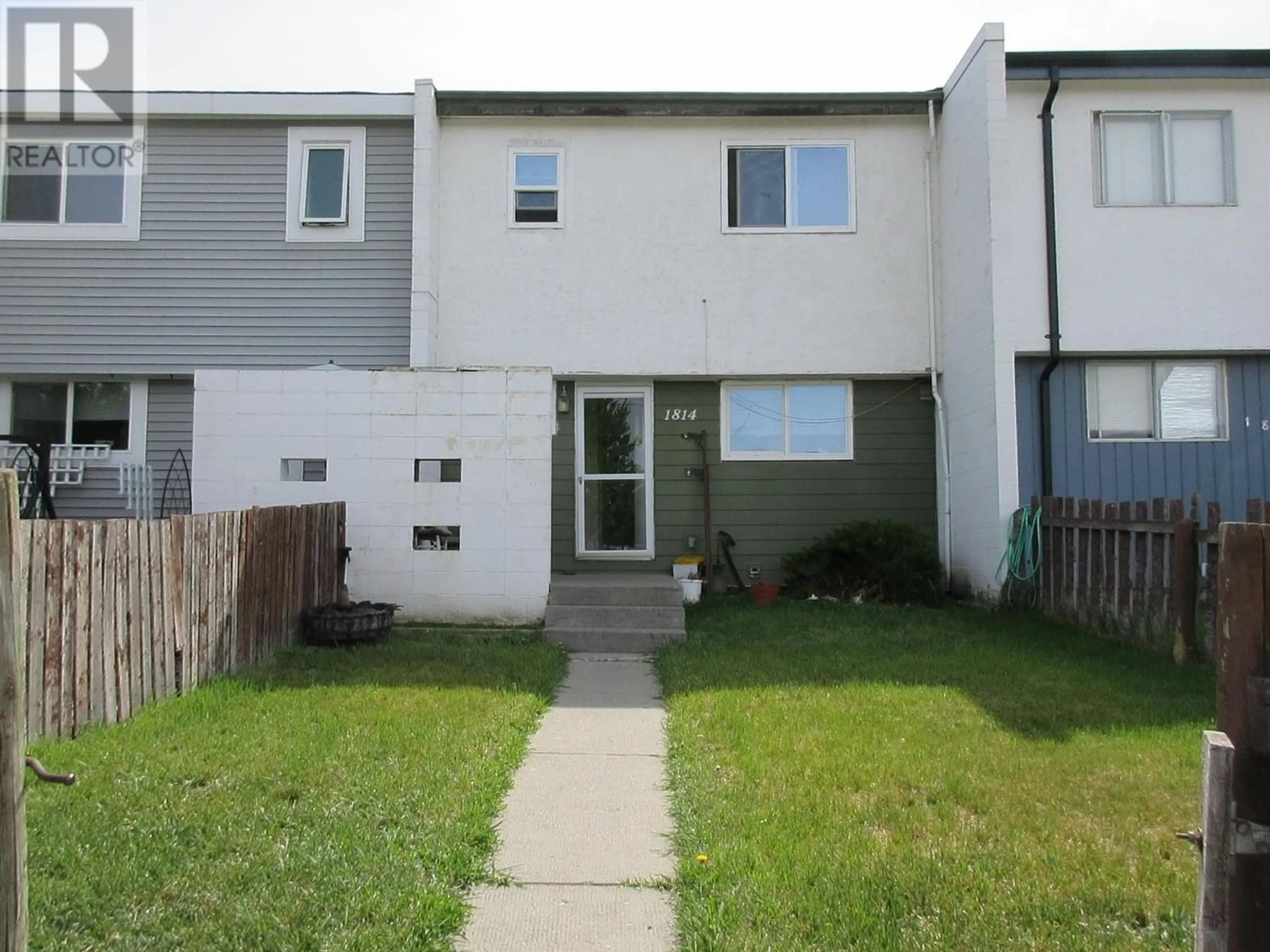 A pic from exterior of the house or condo, the fenced backyard for 1814 DOUGLAS Street, Merritt British Columbia V1K1G7