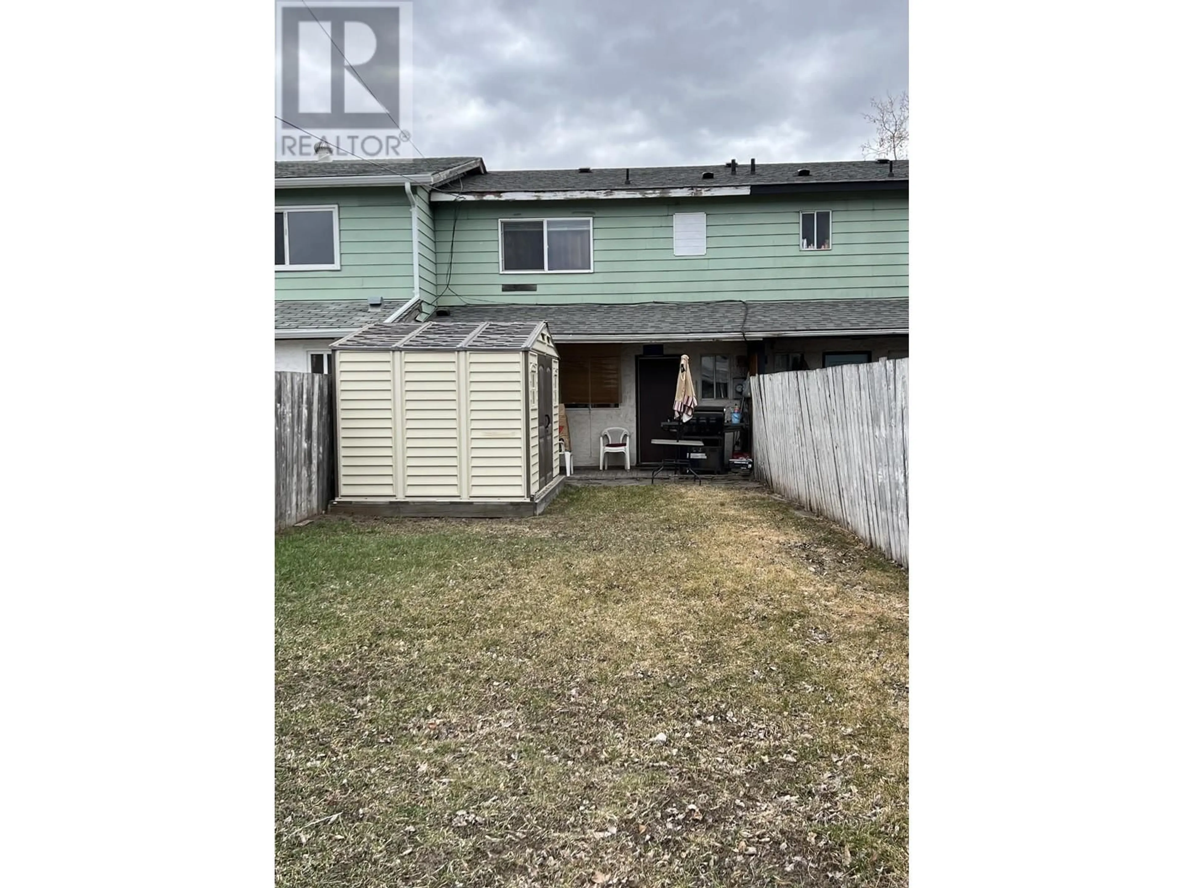 A pic from exterior of the house or condo, the fenced backyard for 1843 MENZIES Street, Merritt British Columbia V1K1E4