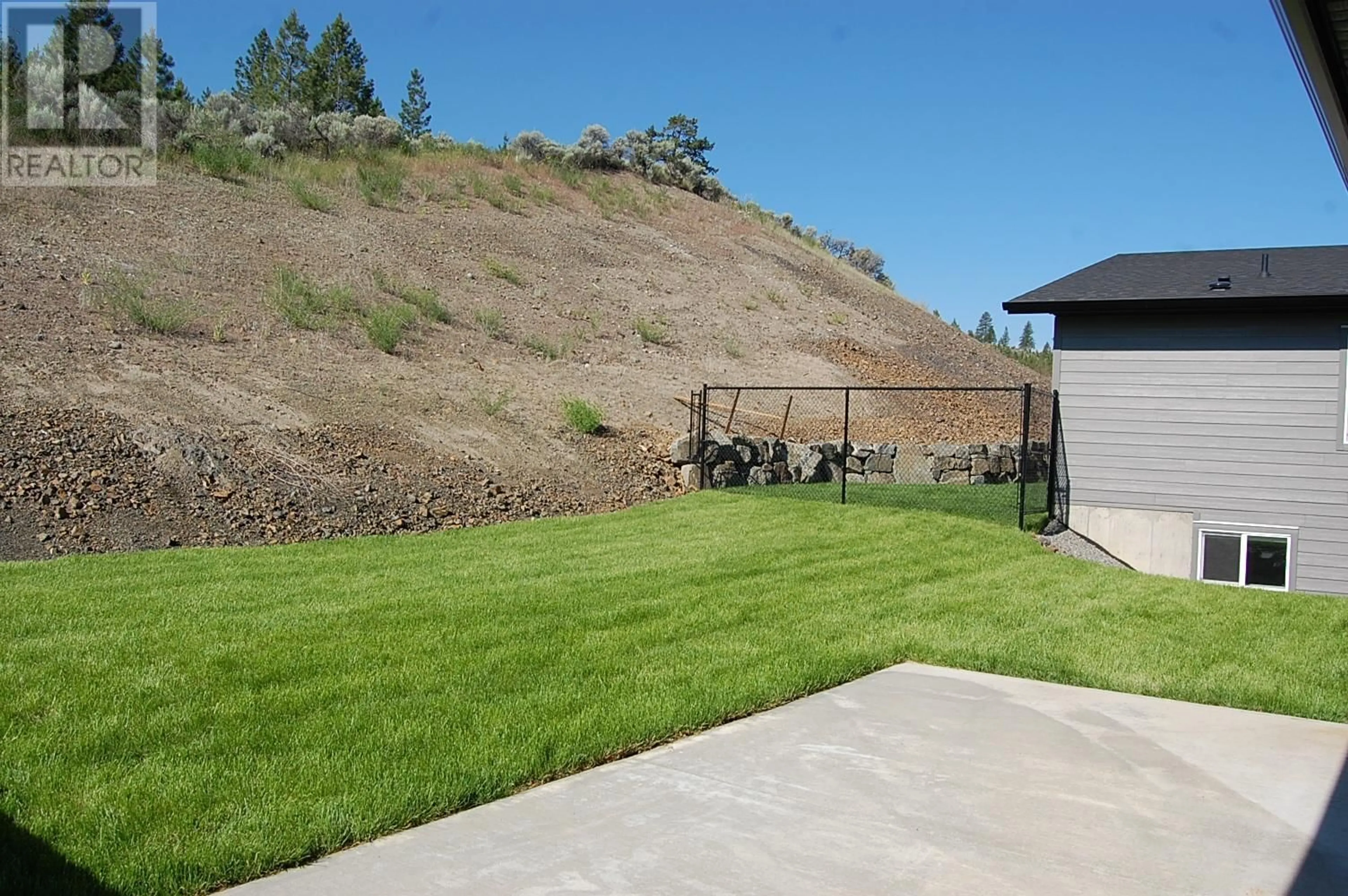 Frontside or backside of a home, the fenced backyard for 2173 GALORE Crescent, Kamloops British Columbia V2C0E4