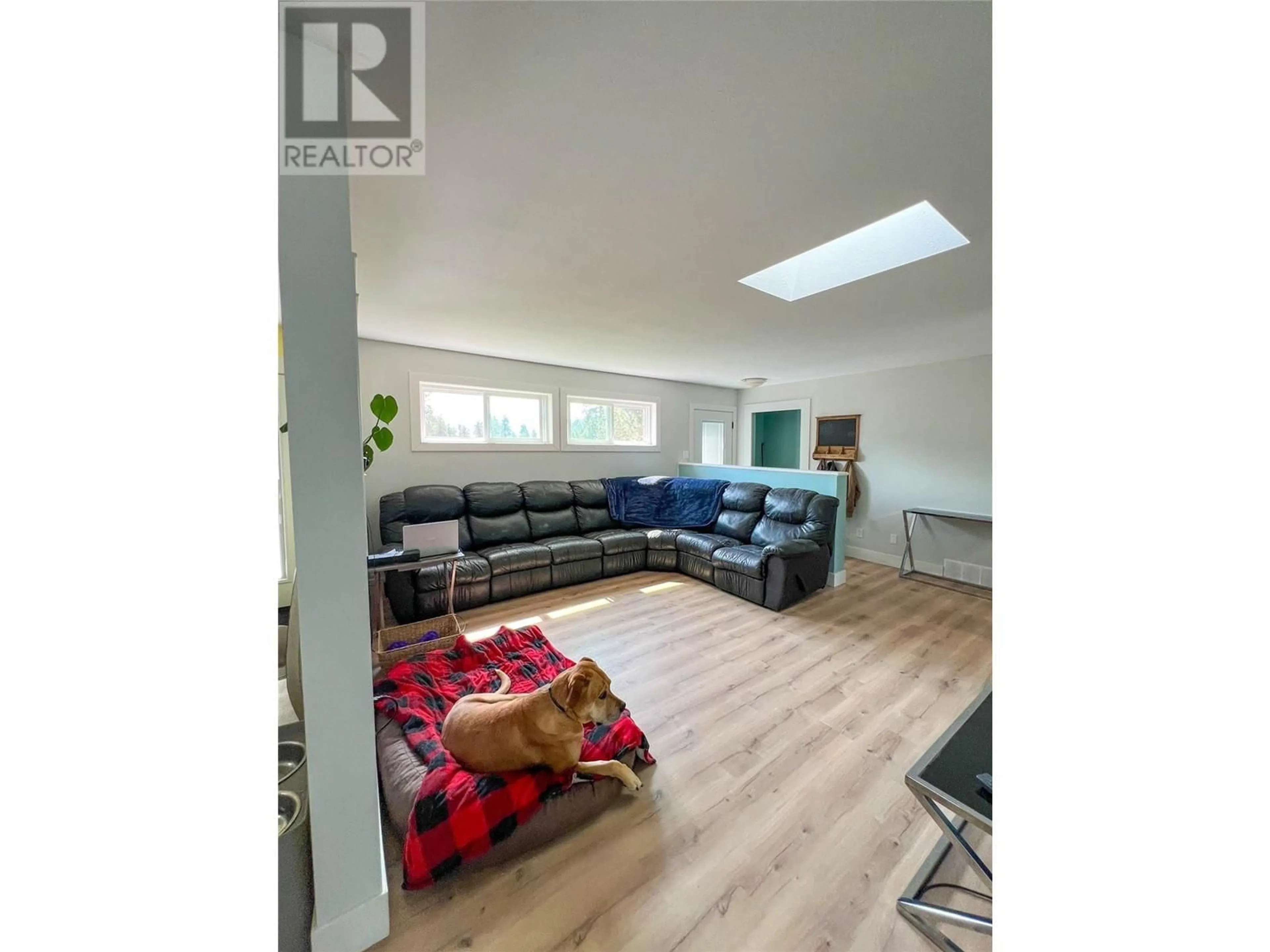 Living room with furniture, wood/laminate floor for 310 GUICHON AVENUE, Merritt British Columbia V0K1Y0