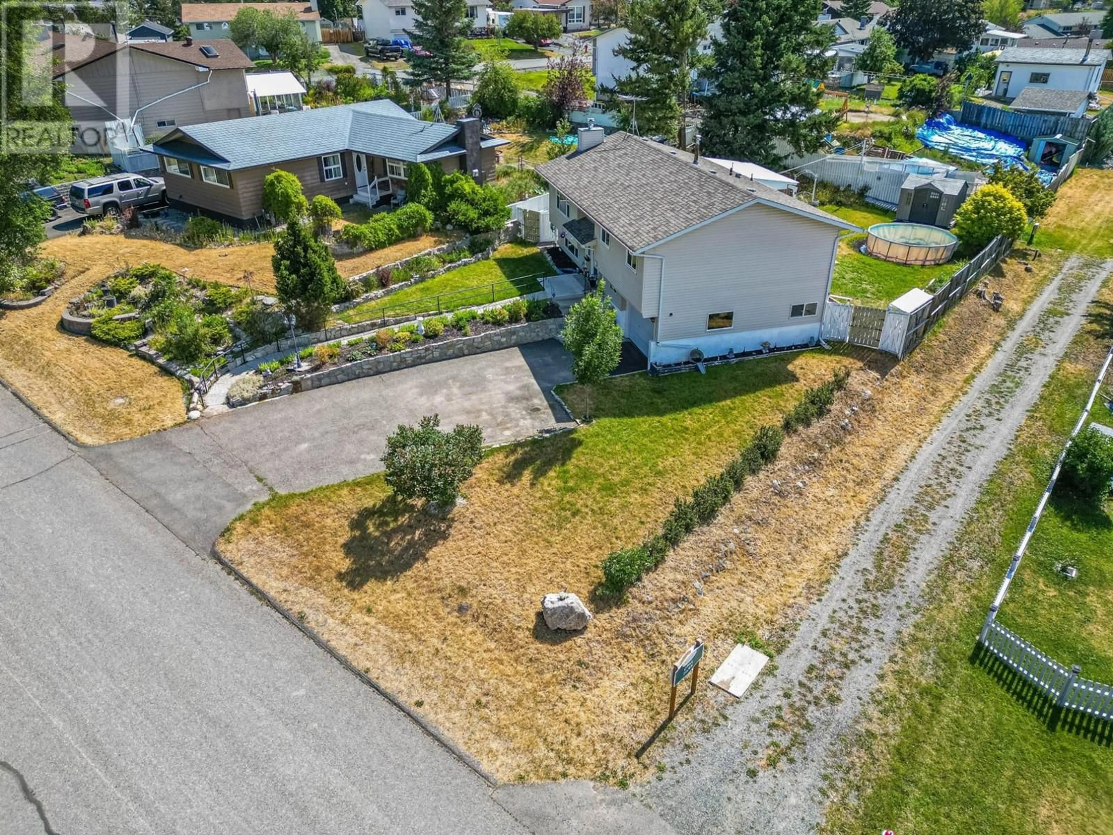 Frontside or backside of a home, the fenced backyard for 443 OPAL Drive, Logan Lake British Columbia V0K1W0