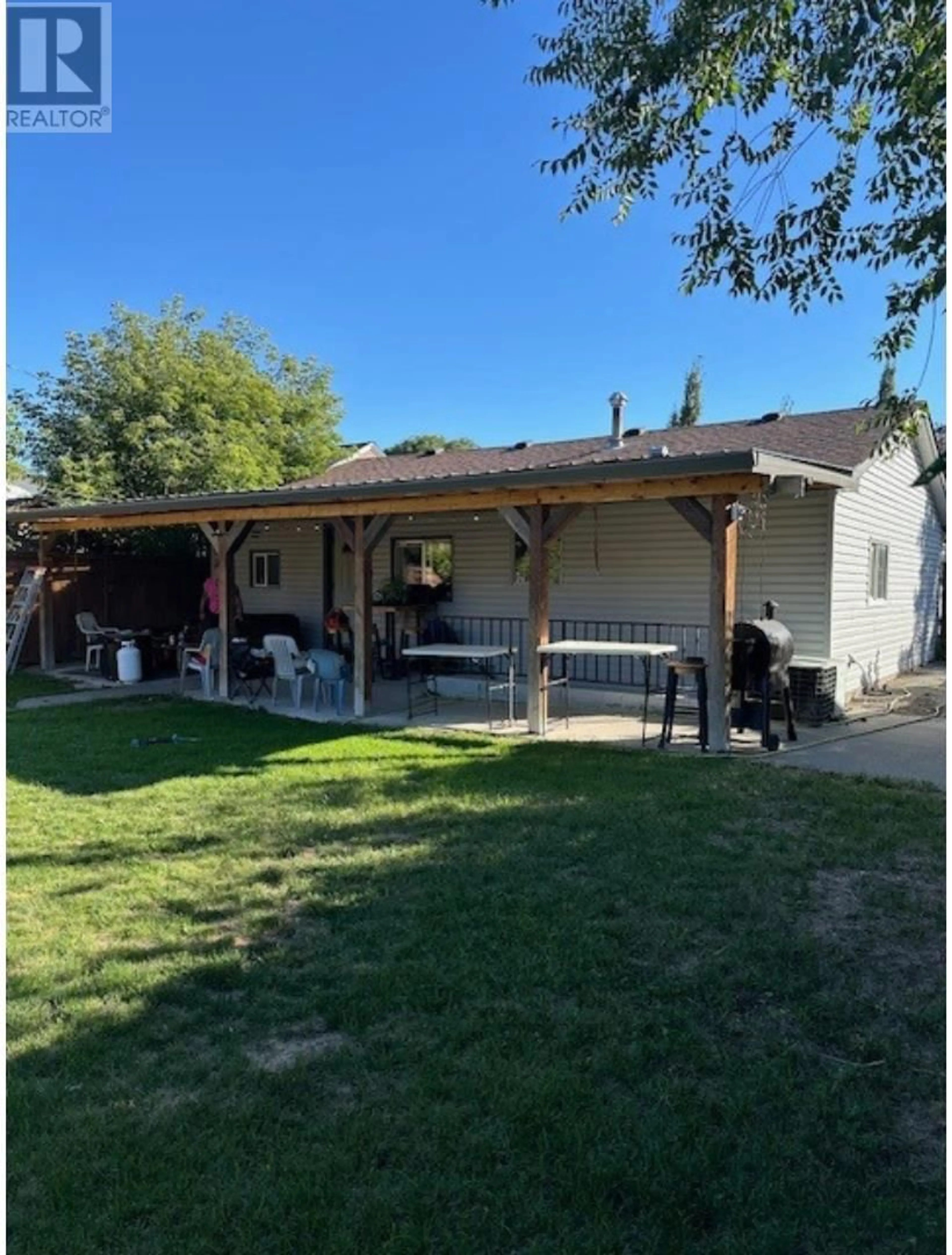 Frontside or backside of a home, the fenced backyard for 1851 NICOLA Avenue, Merritt British Columbia V1K1B8