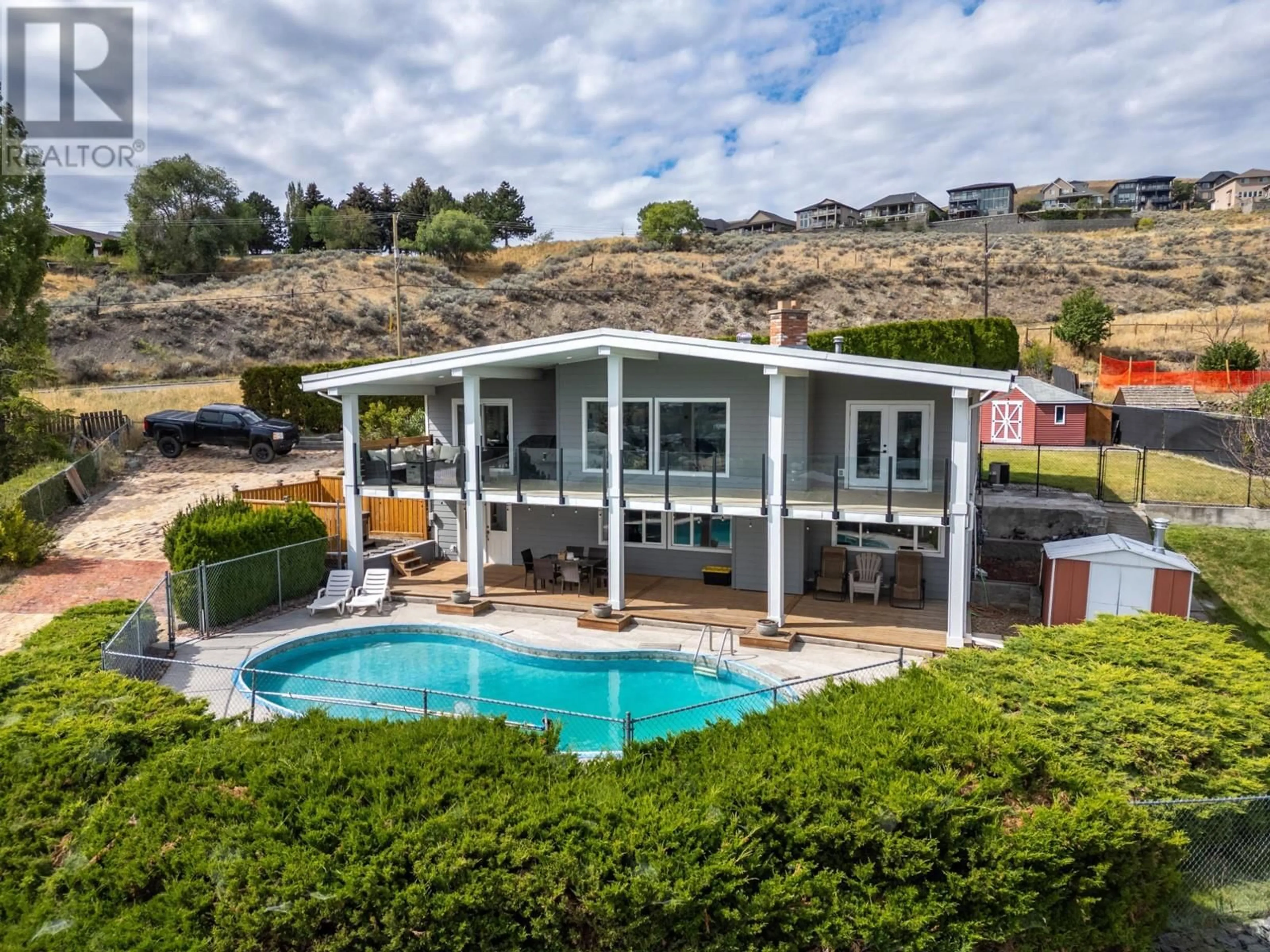 Frontside or backside of a home, the fenced backyard for 1744 PENNASK Terrace, Kamloops British Columbia V2B7N8