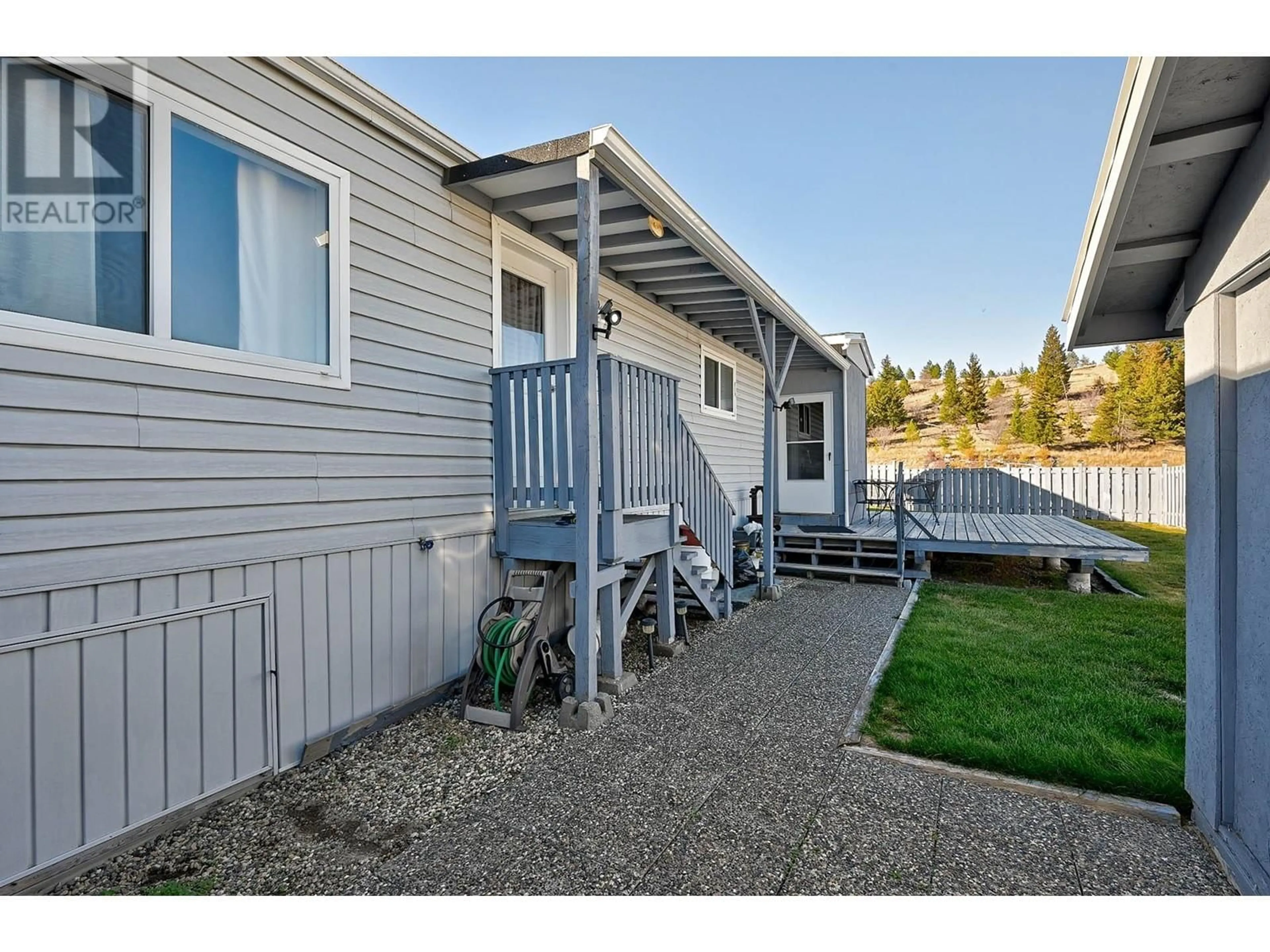 A pic from exterior of the house or condo, the fenced backyard for 1555 HOWE Road Unit# 119, Kamloops British Columbia V1S1Y4