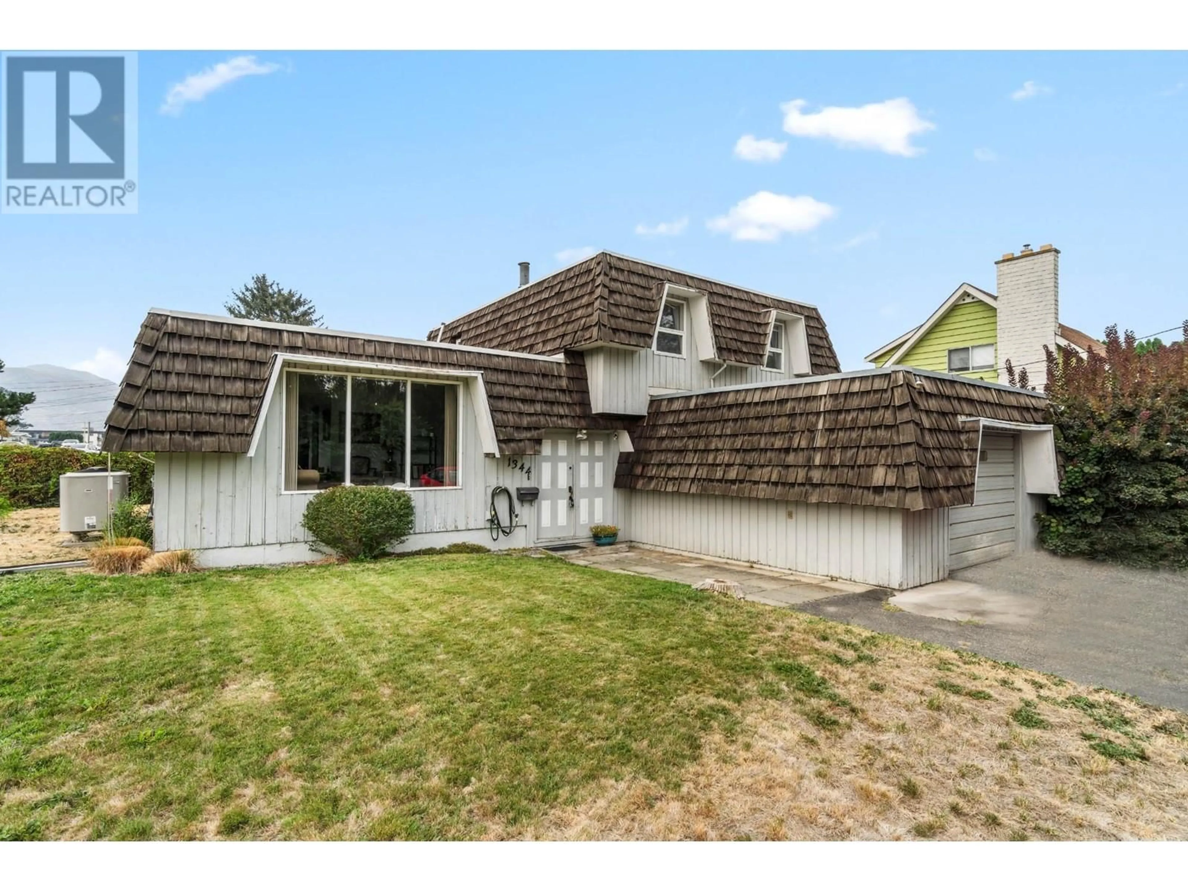 Frontside or backside of a home, the fenced backyard for 1344 KENORA Road, Kamloops British Columbia V2B3X7