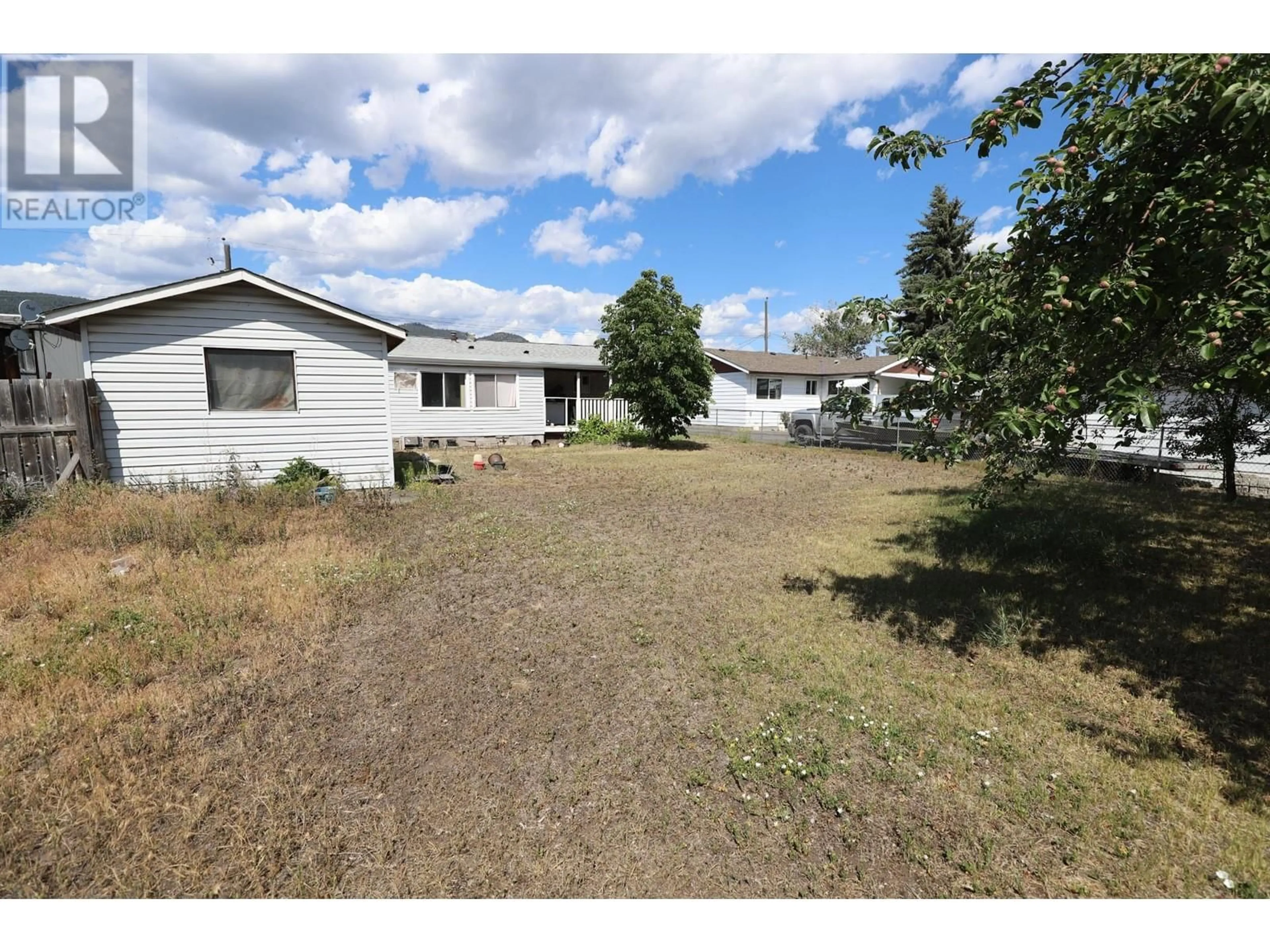 Frontside or backside of a home, the fenced backyard for 2128 CLAPPERTON Avenue, Merritt British Columbia V1K1B8