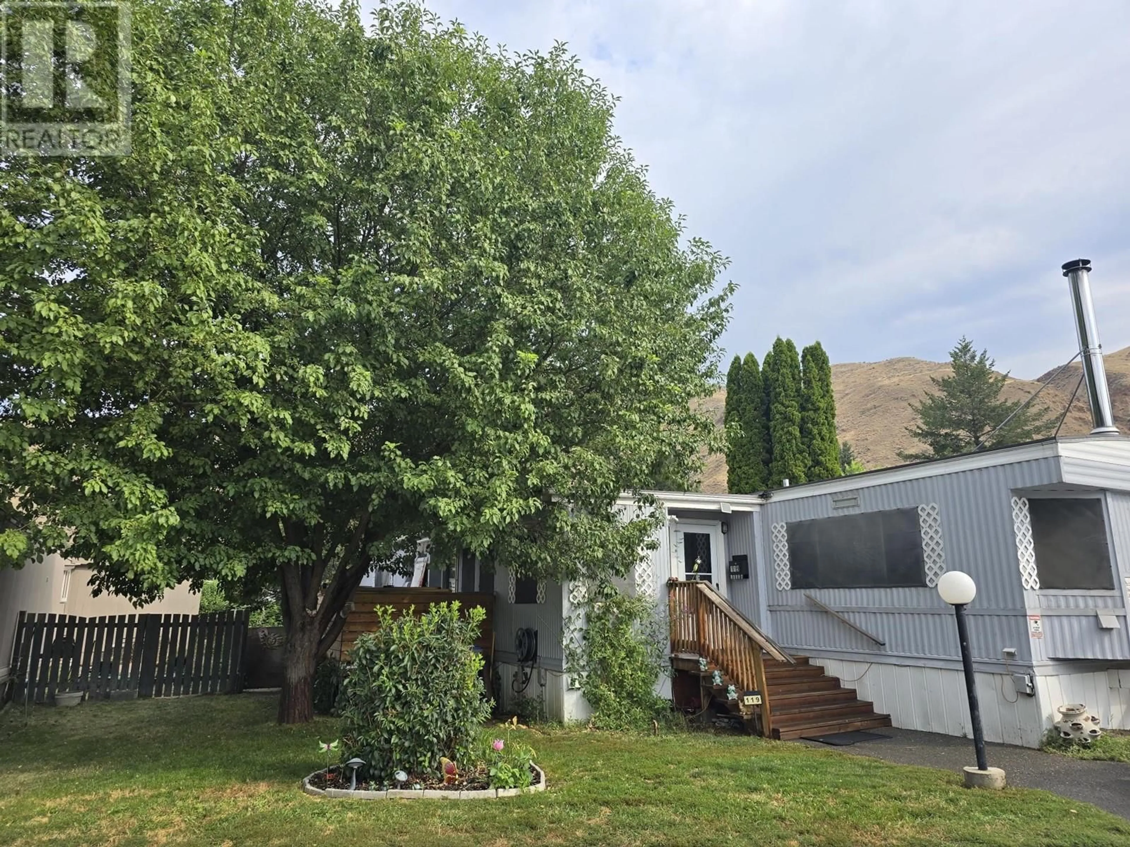 A pic from exterior of the house or condo, the fenced backyard for 2401 Ord Road Unit# 119, Kamloops British Columbia V2B7V8