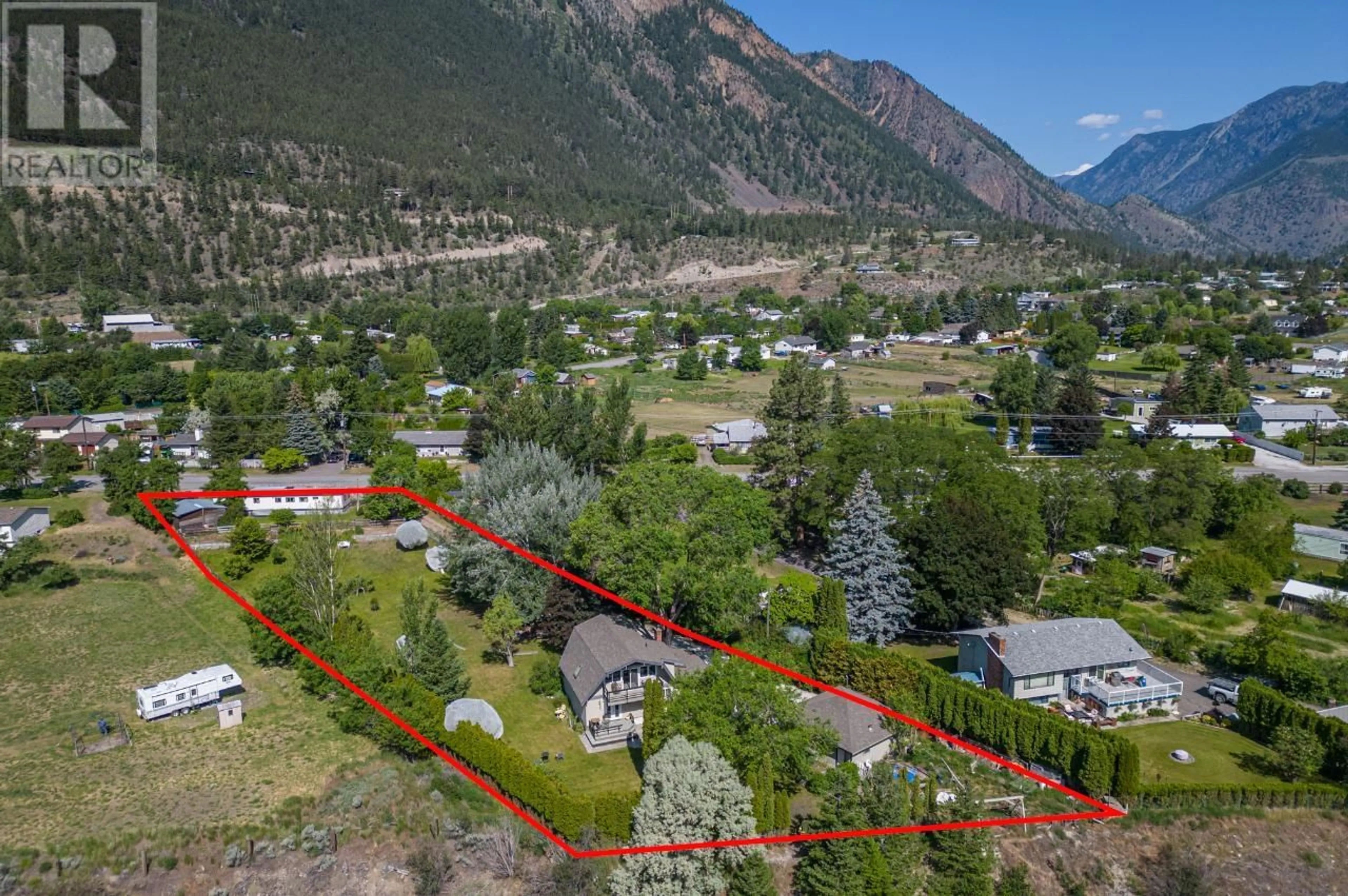 A pic from exterior of the house or condo, the fenced backyard for 371 HOLLYWOOD  Crescent, Lillooet British Columbia V0K1P0