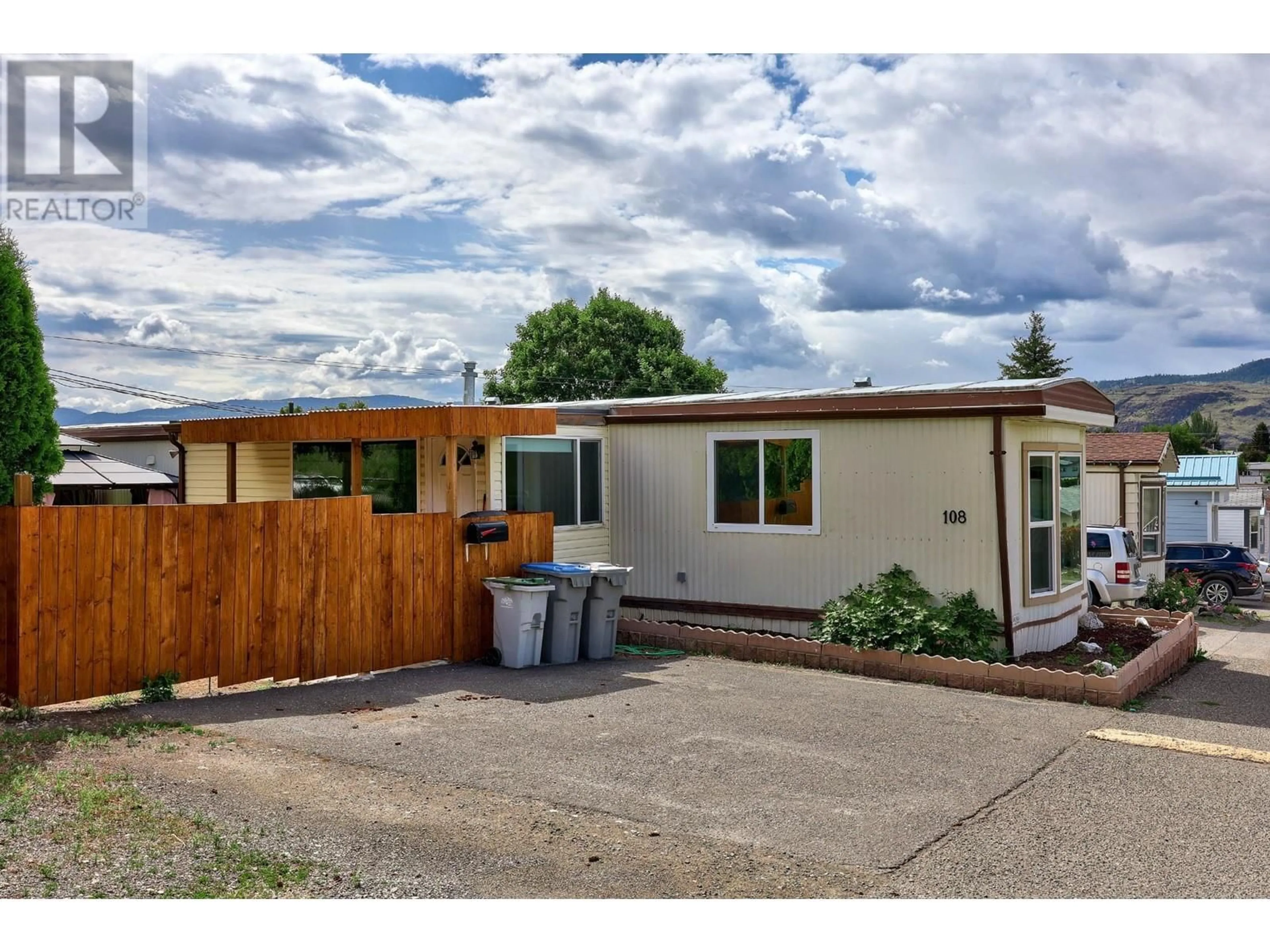 A pic from exterior of the house or condo, the fenced backyard for 1655 Ord Road Unit# 108, Kamloops British Columbia V2B7V6