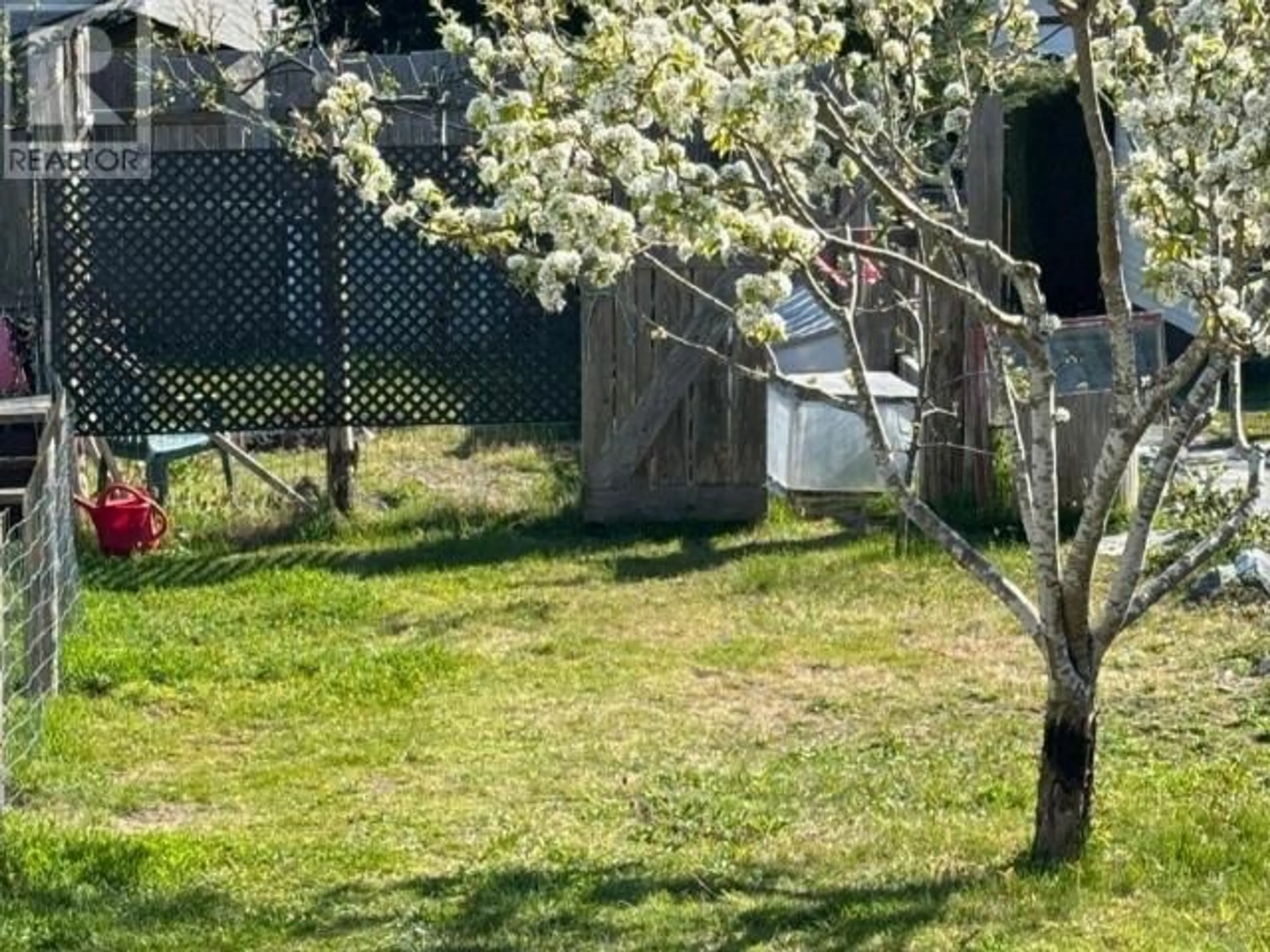 Frontside or backside of a home, the fenced backyard for 1990 WATERMAN AVE, Texada Island British Columbia V0N1W0