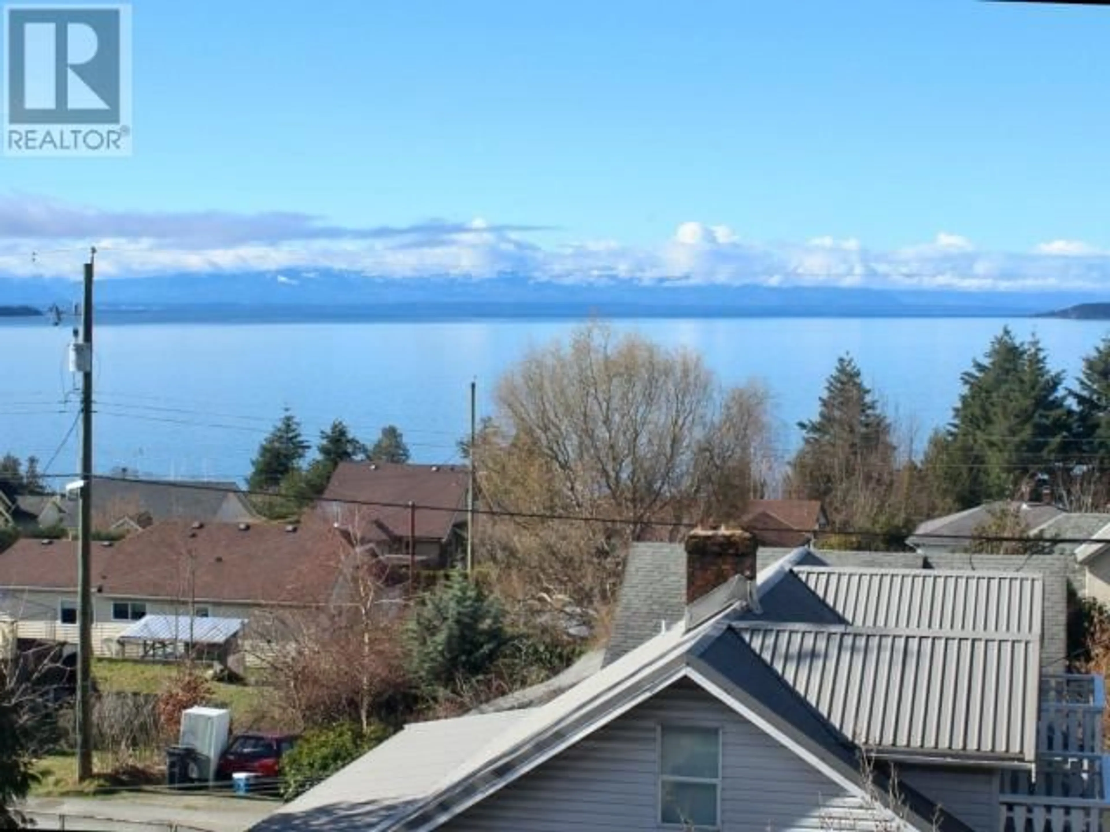 A pic from outside/outdoor area/front of a property/back of a property/a pic from drone, water/lake/river/ocean view for 302-6900 BURNABY STREET, Powell River British Columbia V8A1Y9