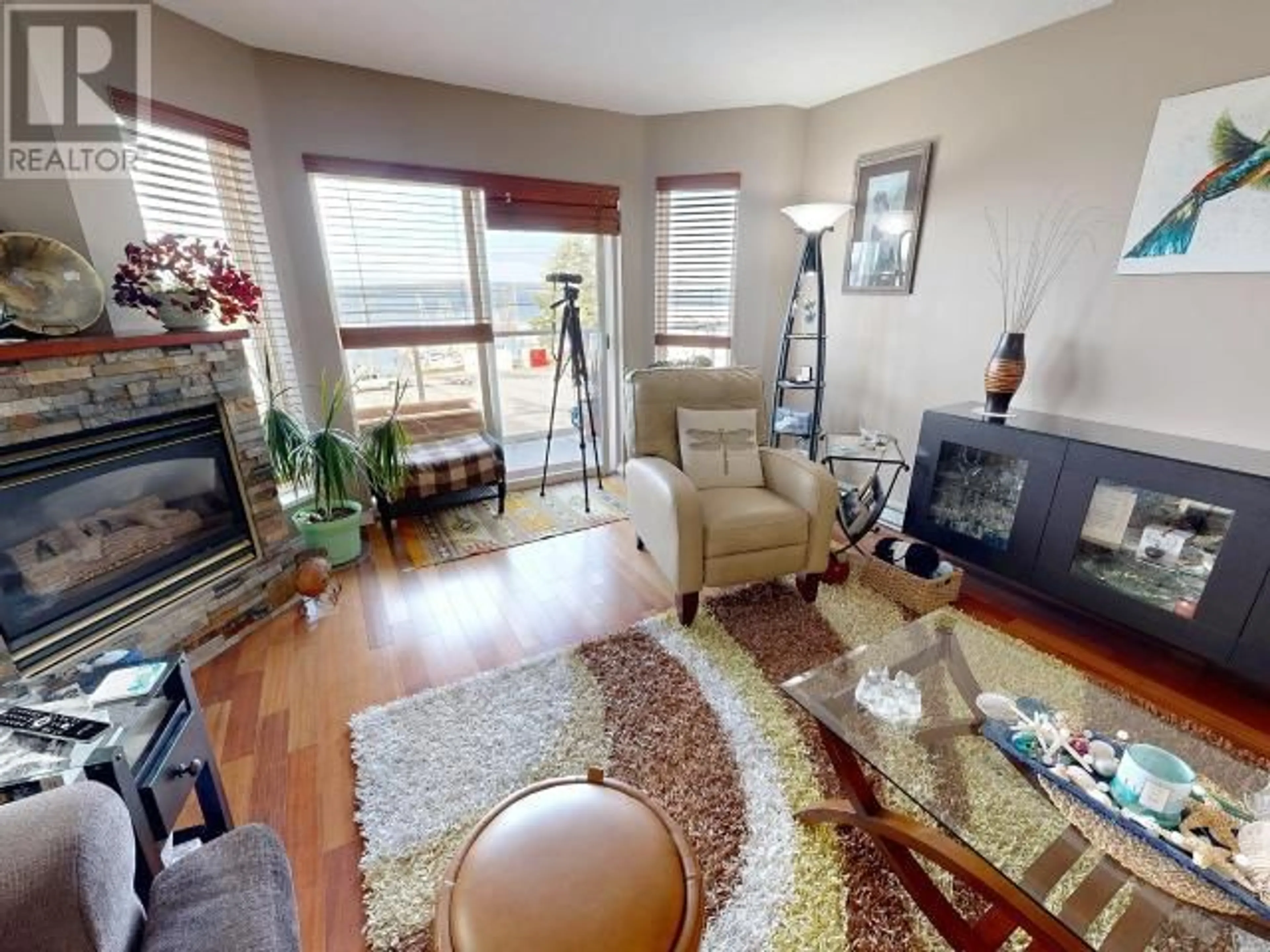 Living room with furniture, wood/laminate floor for 203 - 4510 WILLINGDON AVE, Powell River British Columbia V8A2M8
