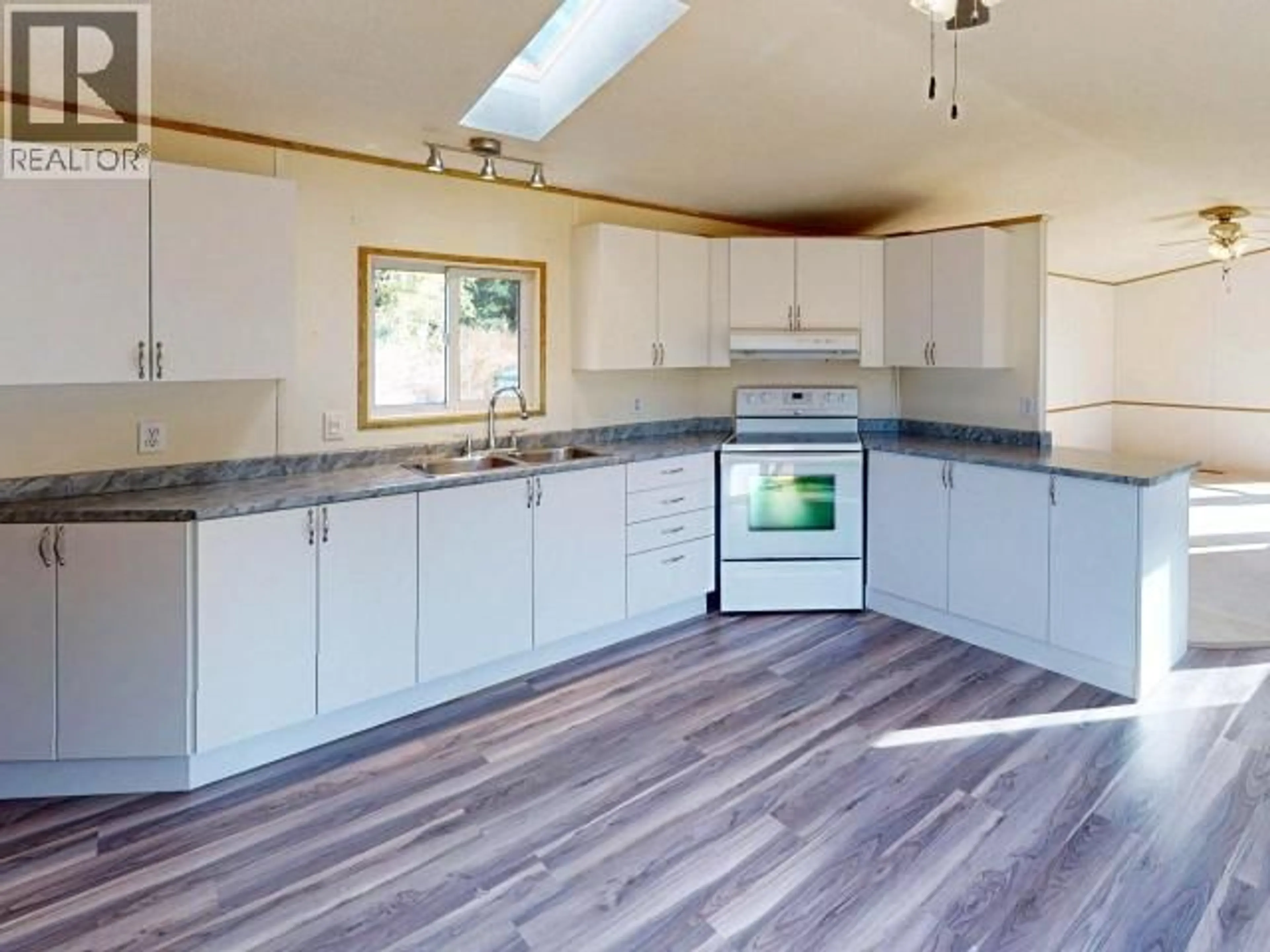 Open concept kitchen, wood/laminate floor for 3043 OAK STREET, Texada Island British Columbia