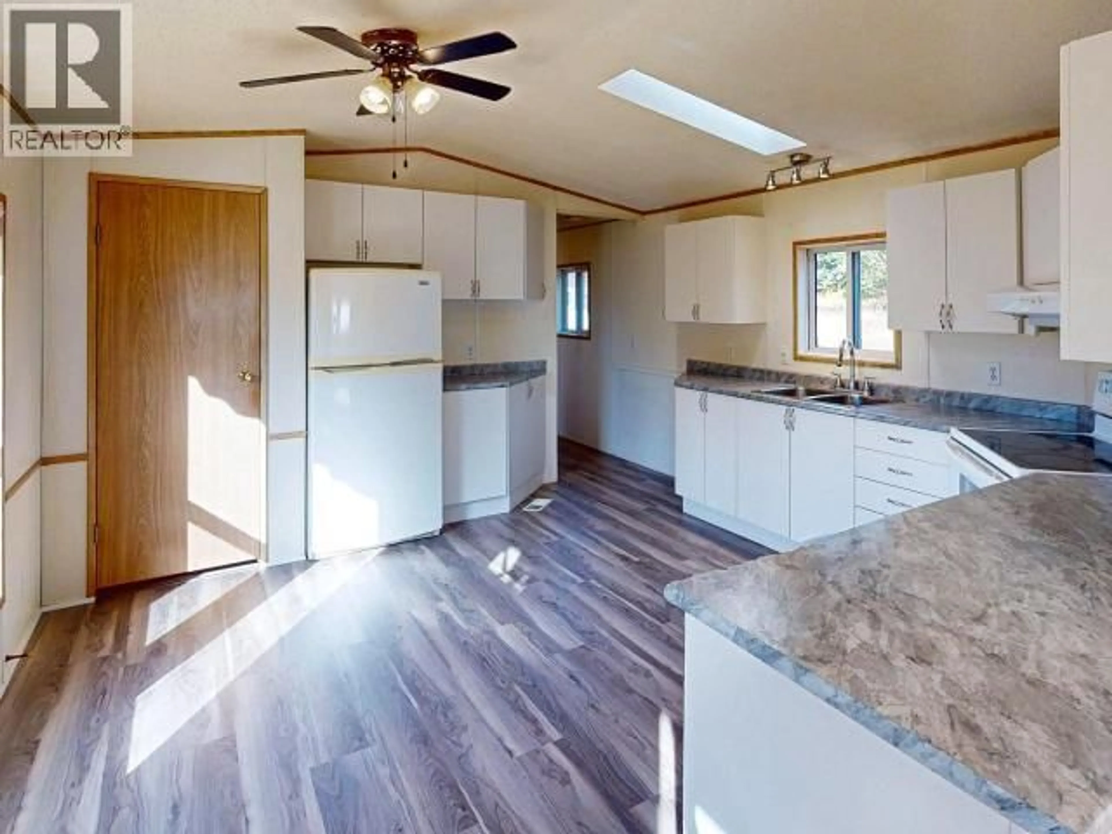 Open concept kitchen, wood/laminate floor for 3043 OAK STREET, Texada Island British Columbia