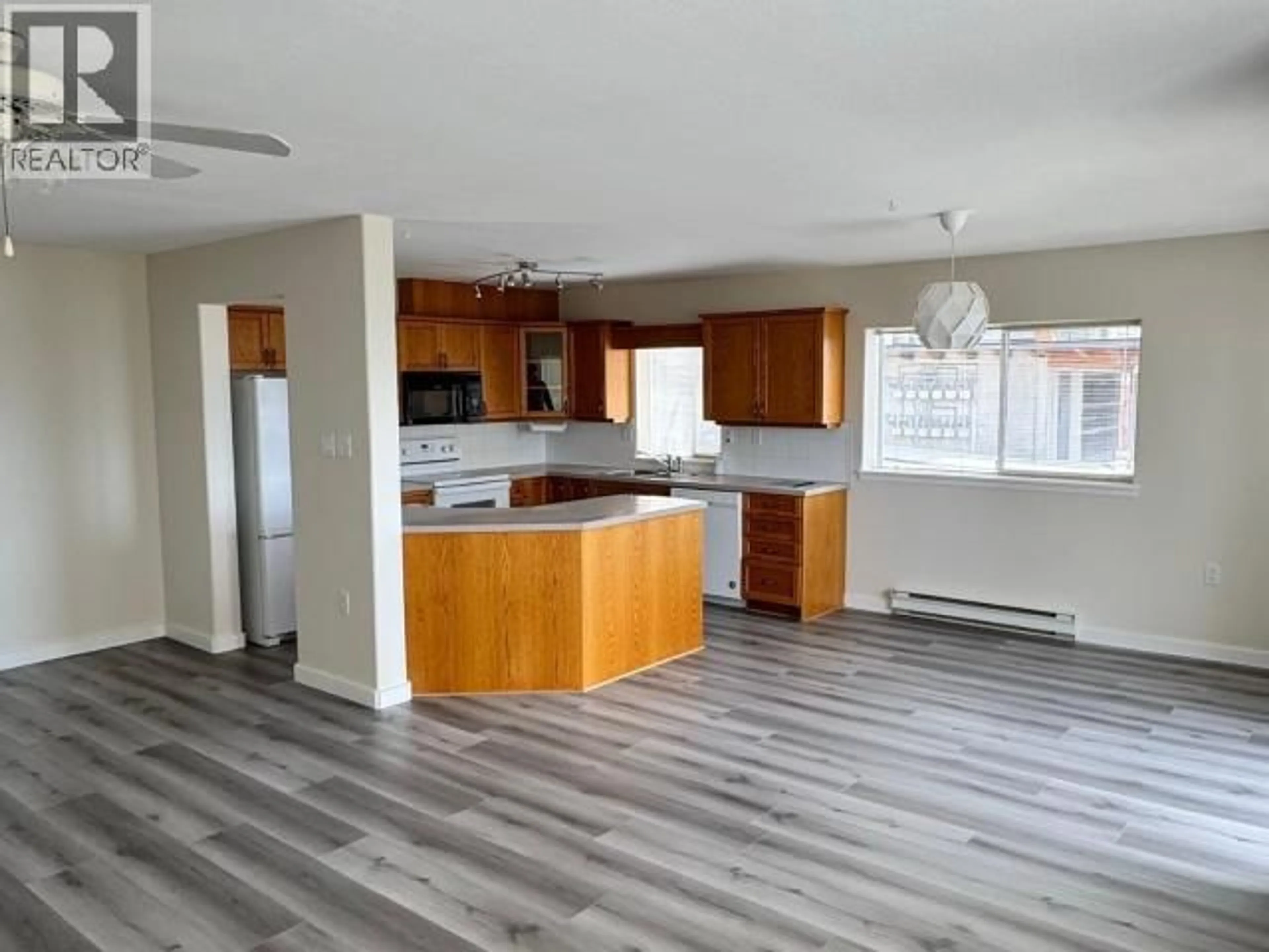 Open concept kitchen, wood/laminate floor for 104 - 6900 BURNABY STREET, Powell River British Columbia V8A5V3