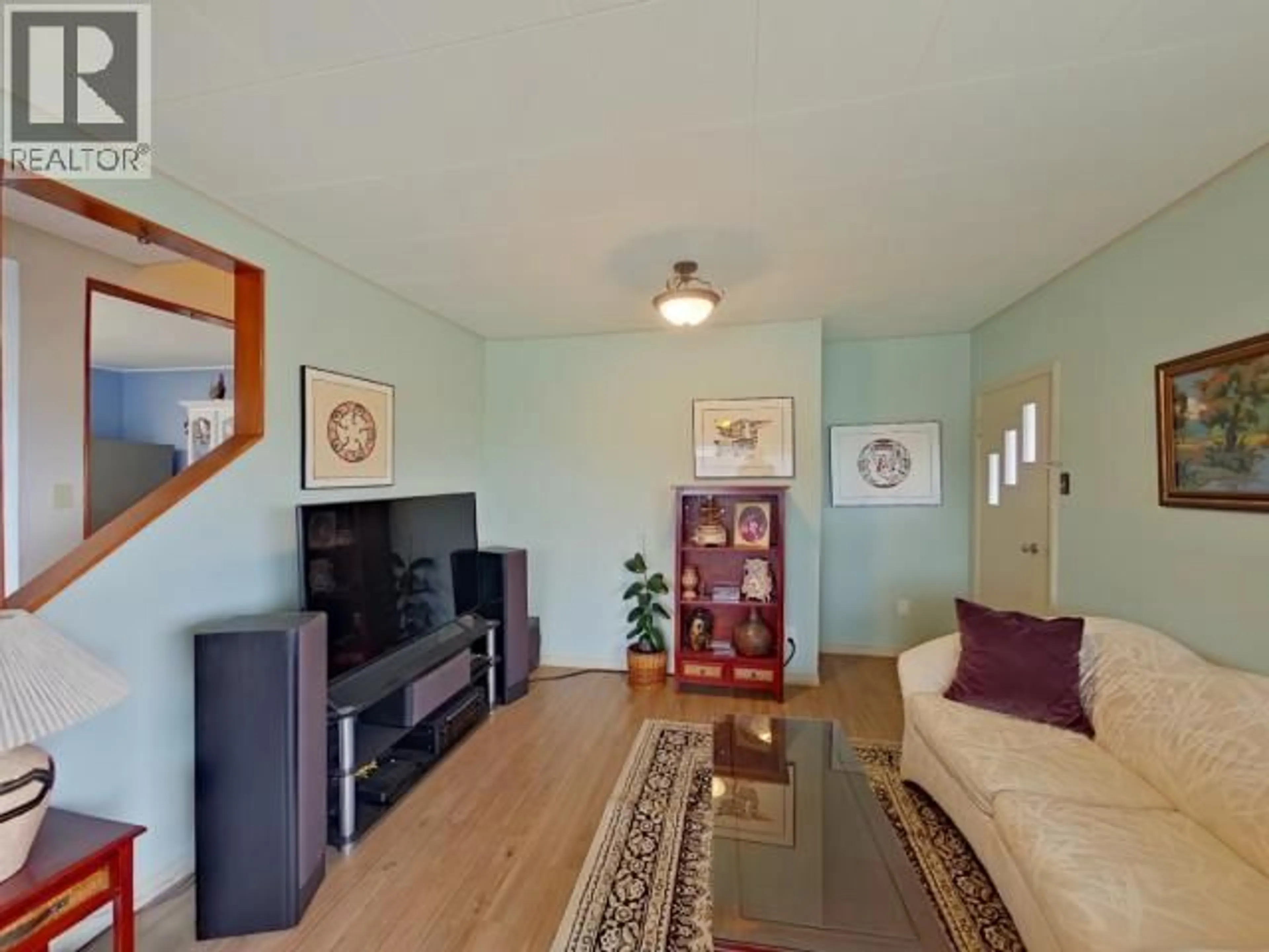 Living room with furniture, wood/laminate floor for 7170 JORDAN STREET, Powell River British Columbia V8A1M9