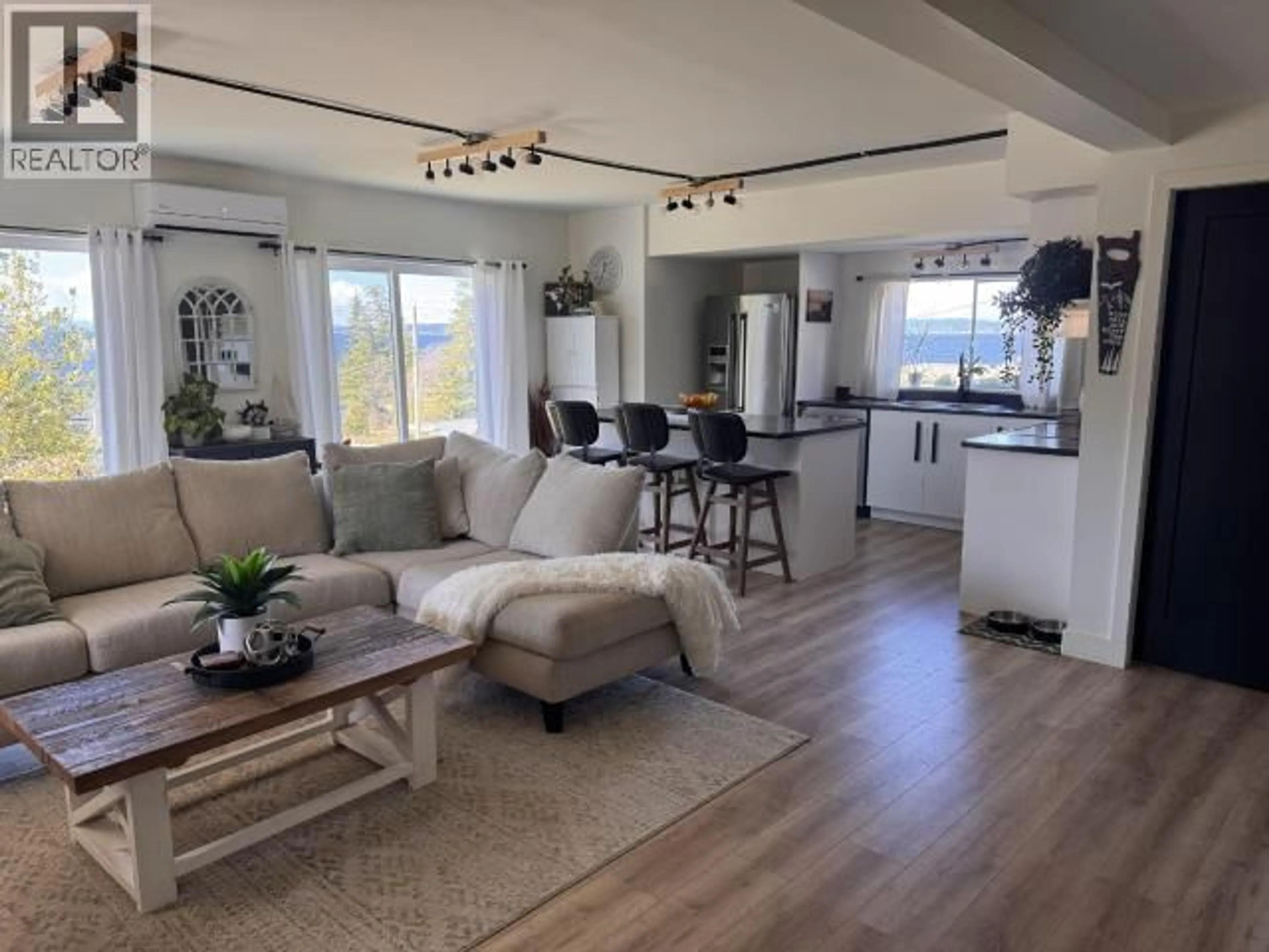 Living room with furniture, wood/laminate floor for 6928 QUESNEL STREET, Powell River British Columbia V8A1J2