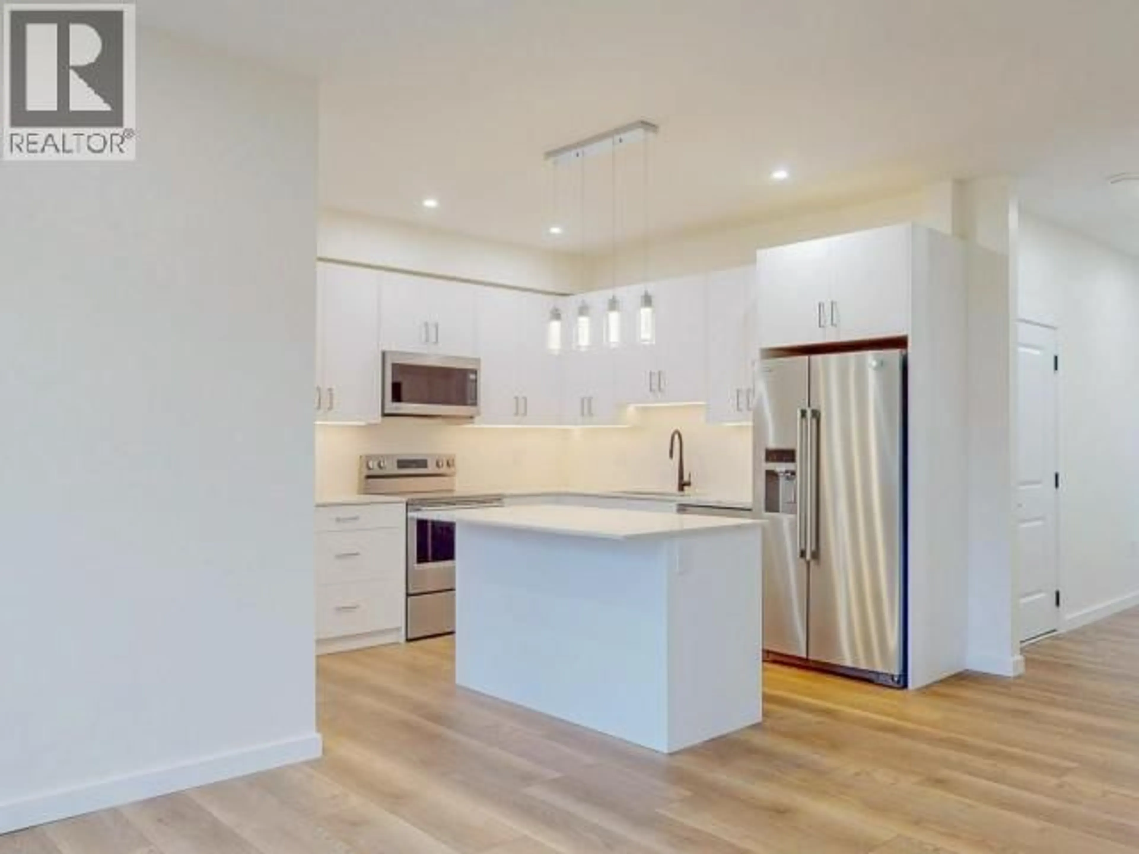 Open concept kitchen, wood/laminate floor for 103 - 5191 MANSON AVE, Powell River British Columbia V8A3P2