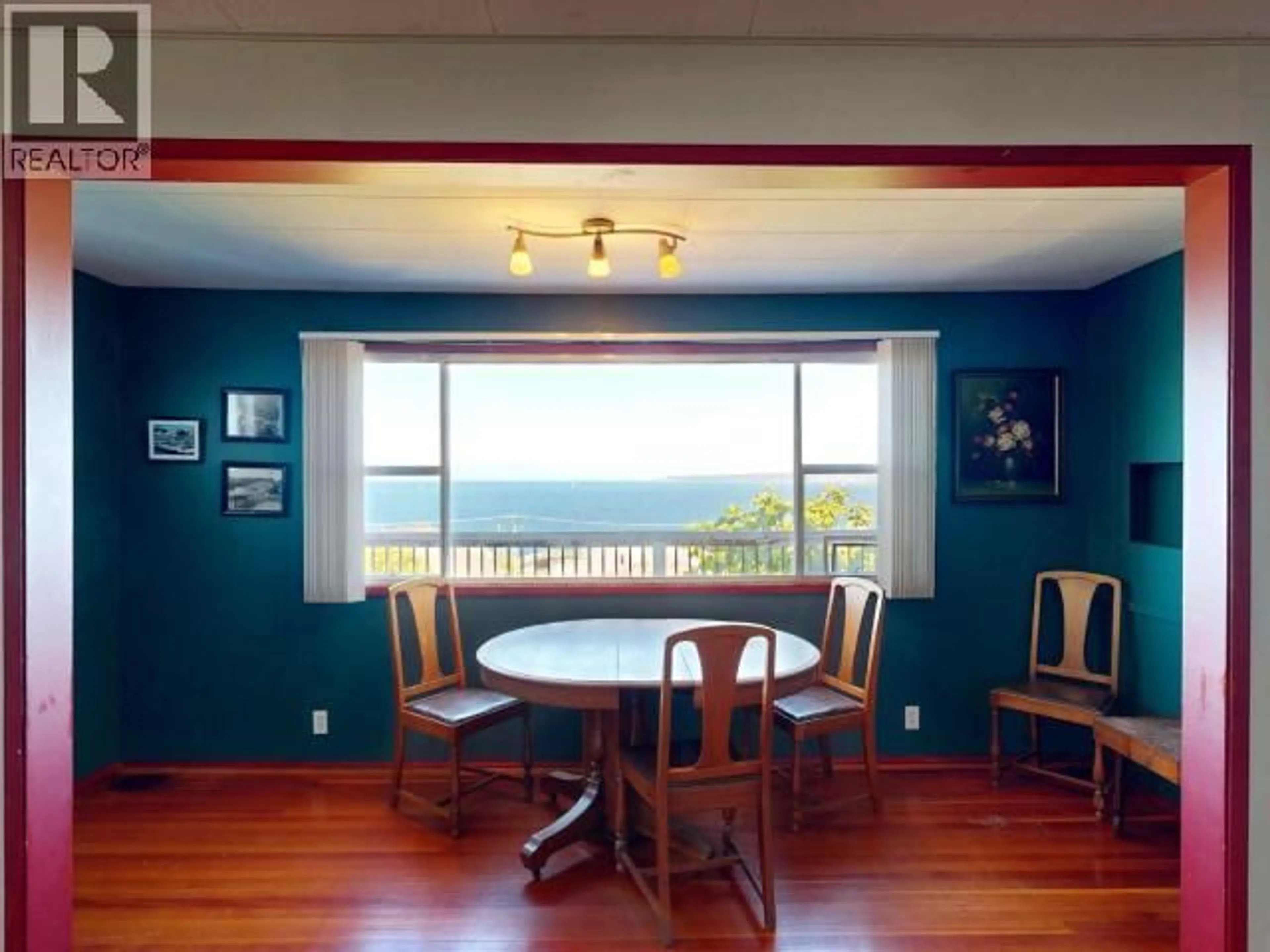 Dining room, wood/laminate floor for 4459 OMINECA AVE, Powell River British Columbia V8A2P8