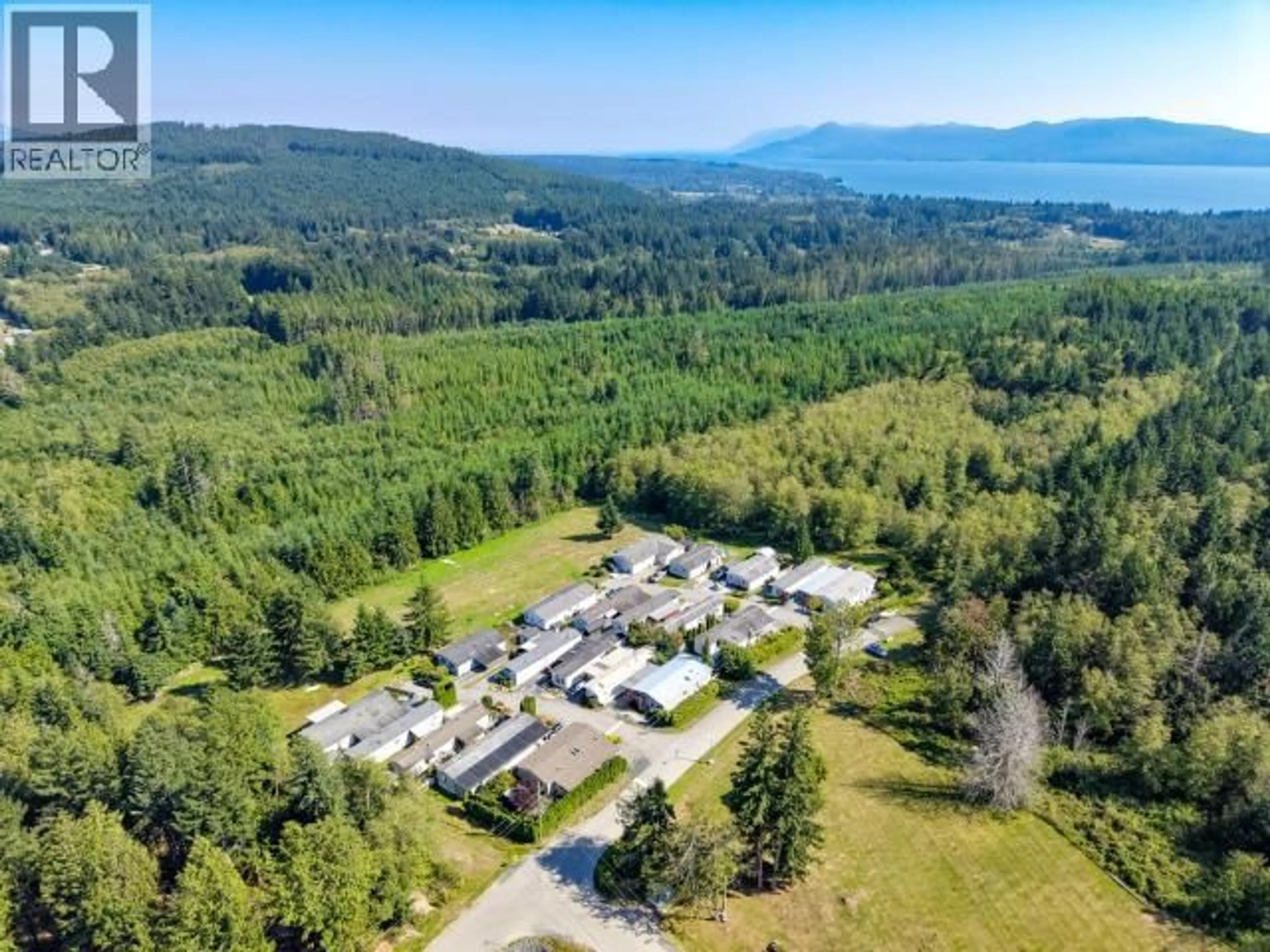 A pic from outside/outdoor area/front of a property/back of a property/a pic from drone, mountain view for 6 - 7520 NOOTKA STREET, Powell River British Columbia V8A5S2