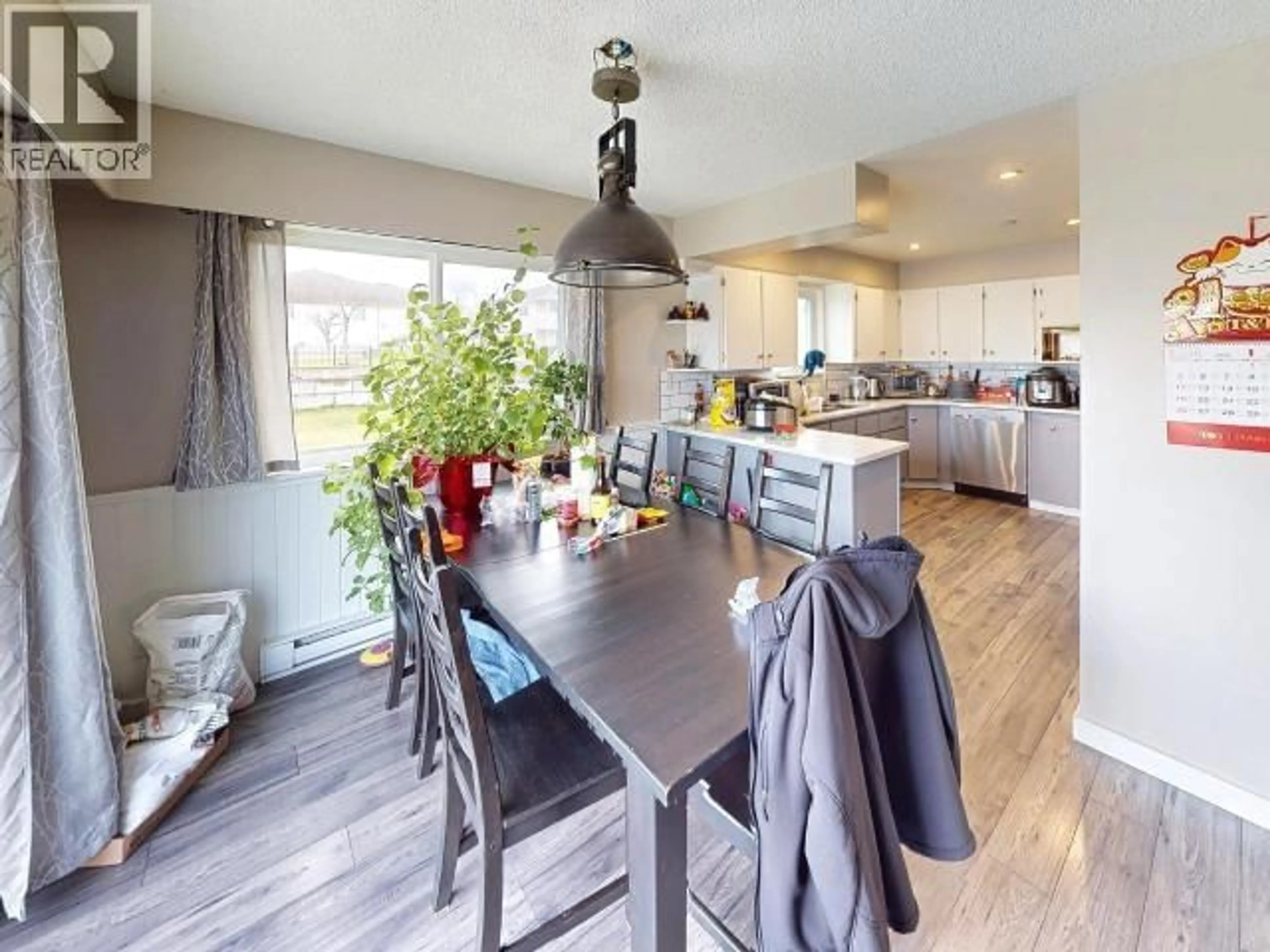 Open concept kitchen, wood/laminate floor for 4922 SASKATCHEWAN AVE, Powell River British Columbia V8A3G4