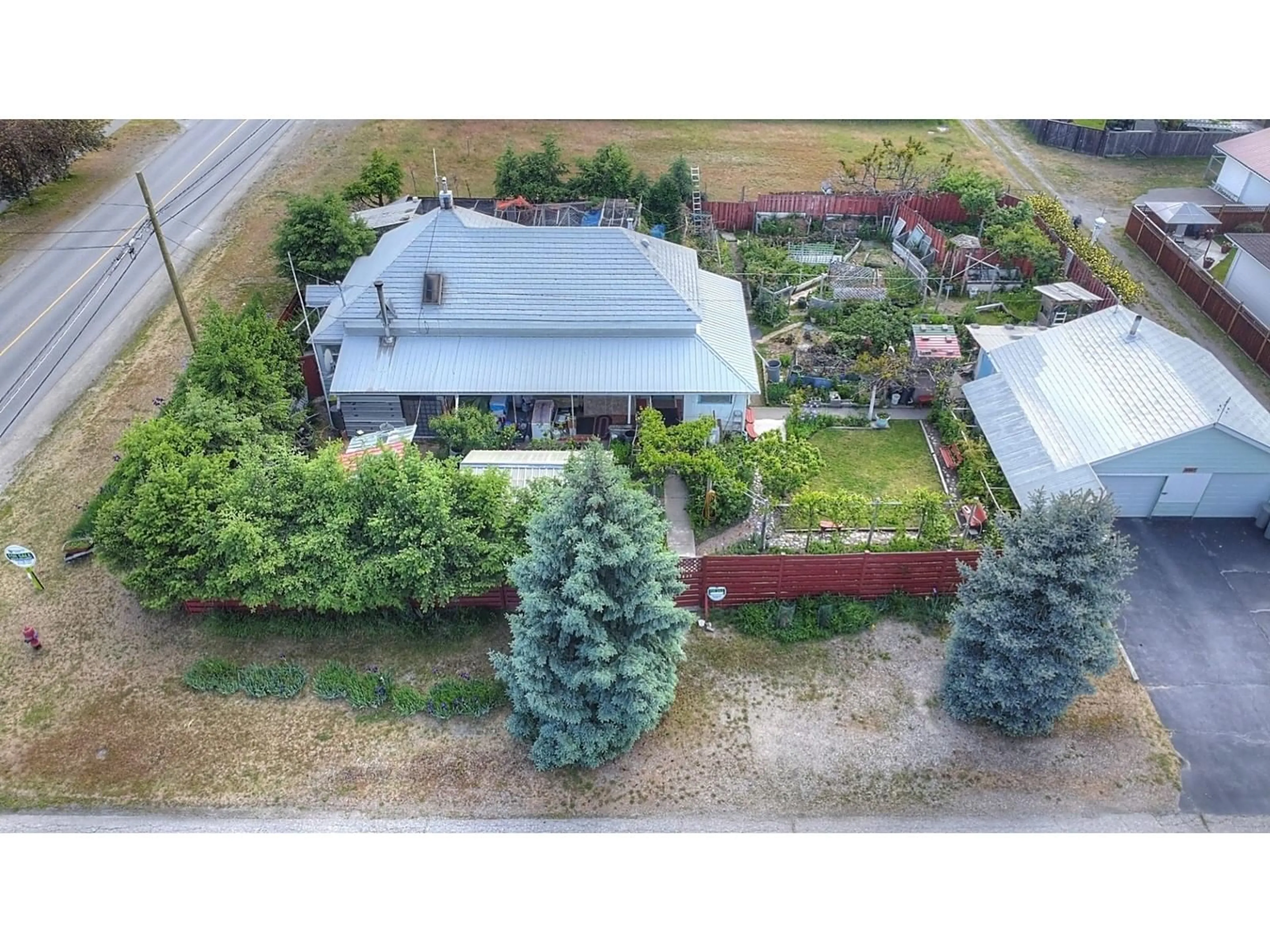 Frontside or backside of a home, the fenced backyard for 1625 68TH Avenue, Grand Forks British Columbia V0H1H0