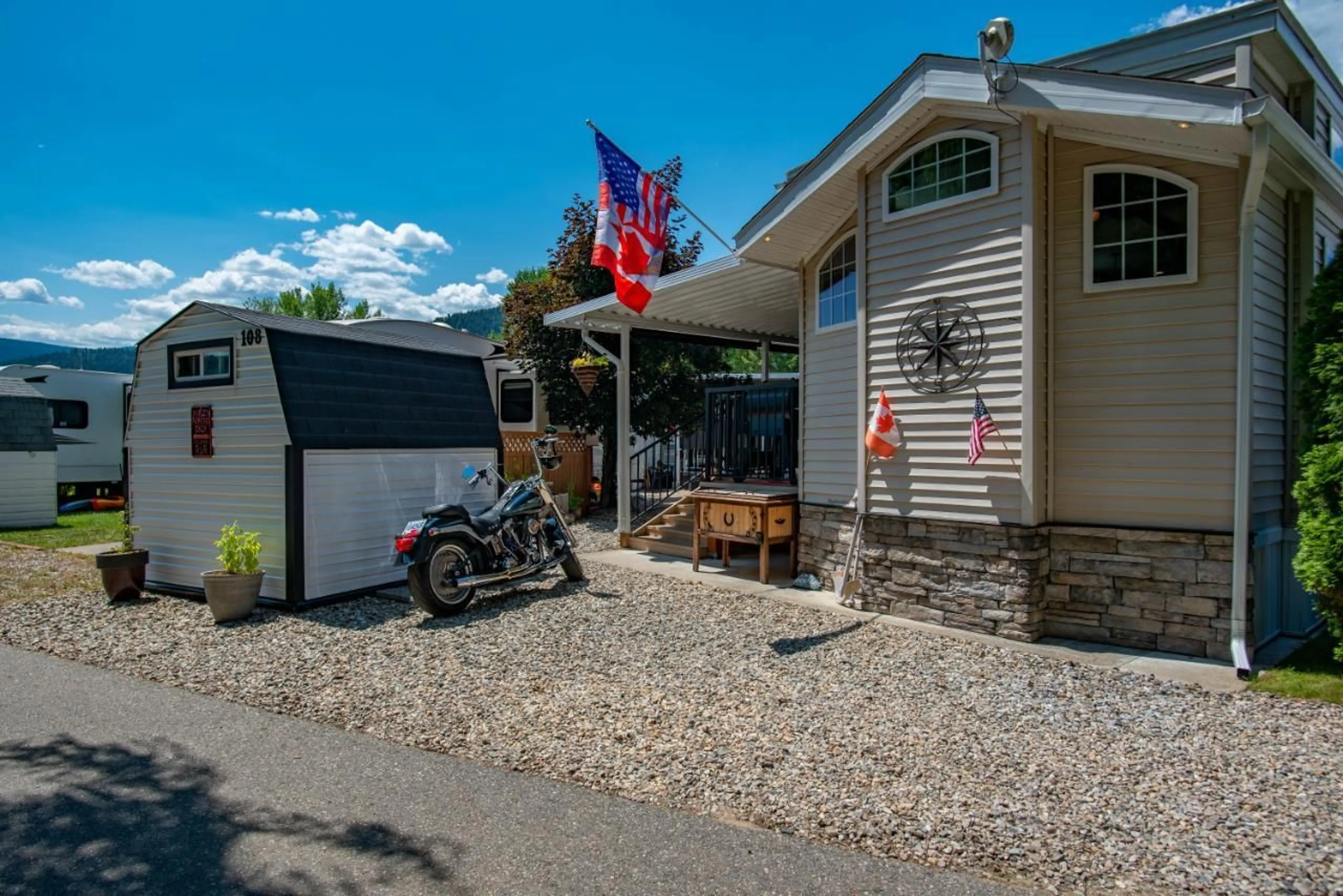 A pic from exterior of the house or condo, the street view for 108 - 1835 BAKERY FRONTAGE ROAD, Christina Lake British Columbia V0H1E0