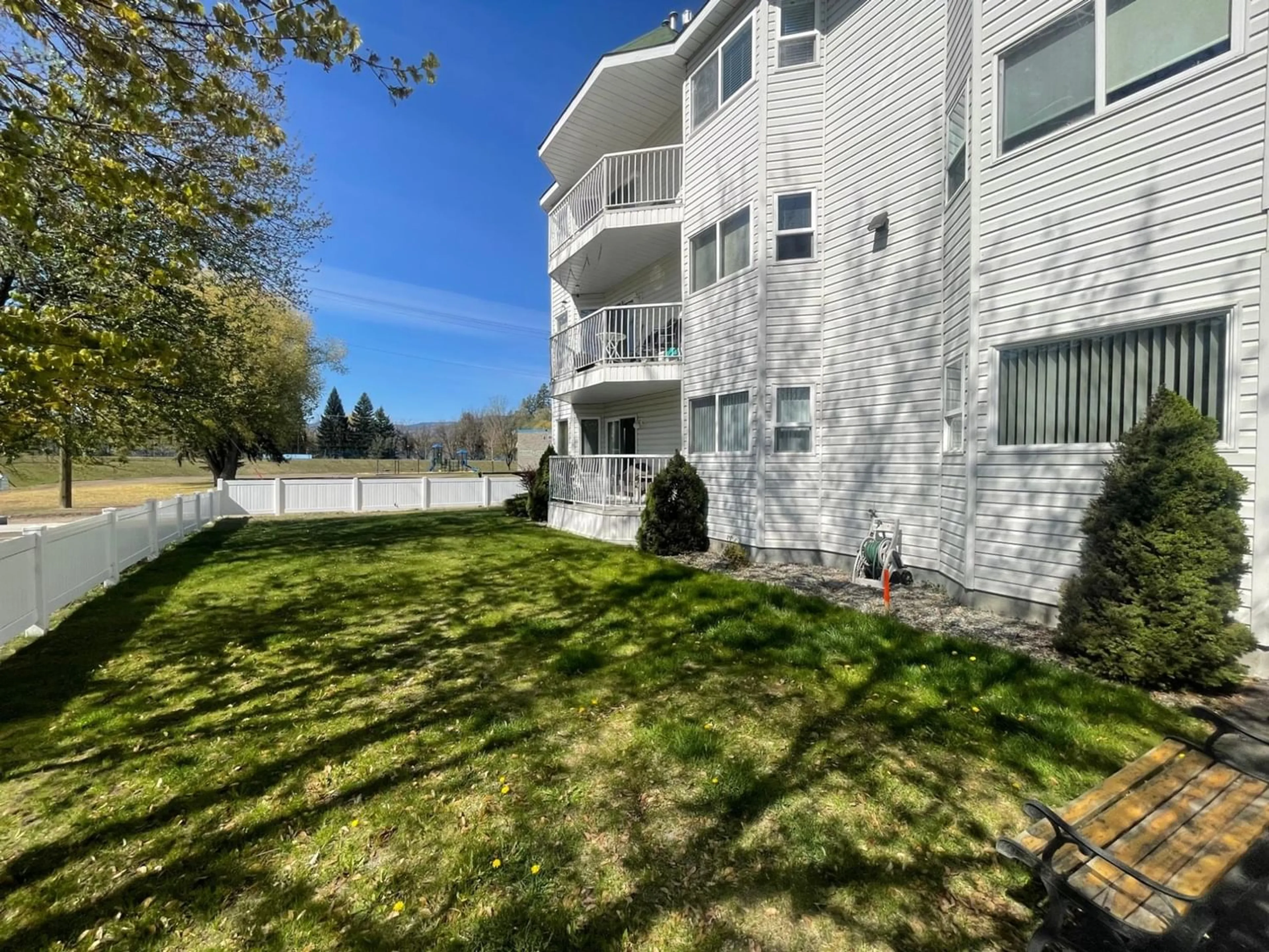 A pic from exterior of the house or condo, the fenced backyard for 7140 4TH Street Unit# 305, Grand Forks British Columbia V0H1H0