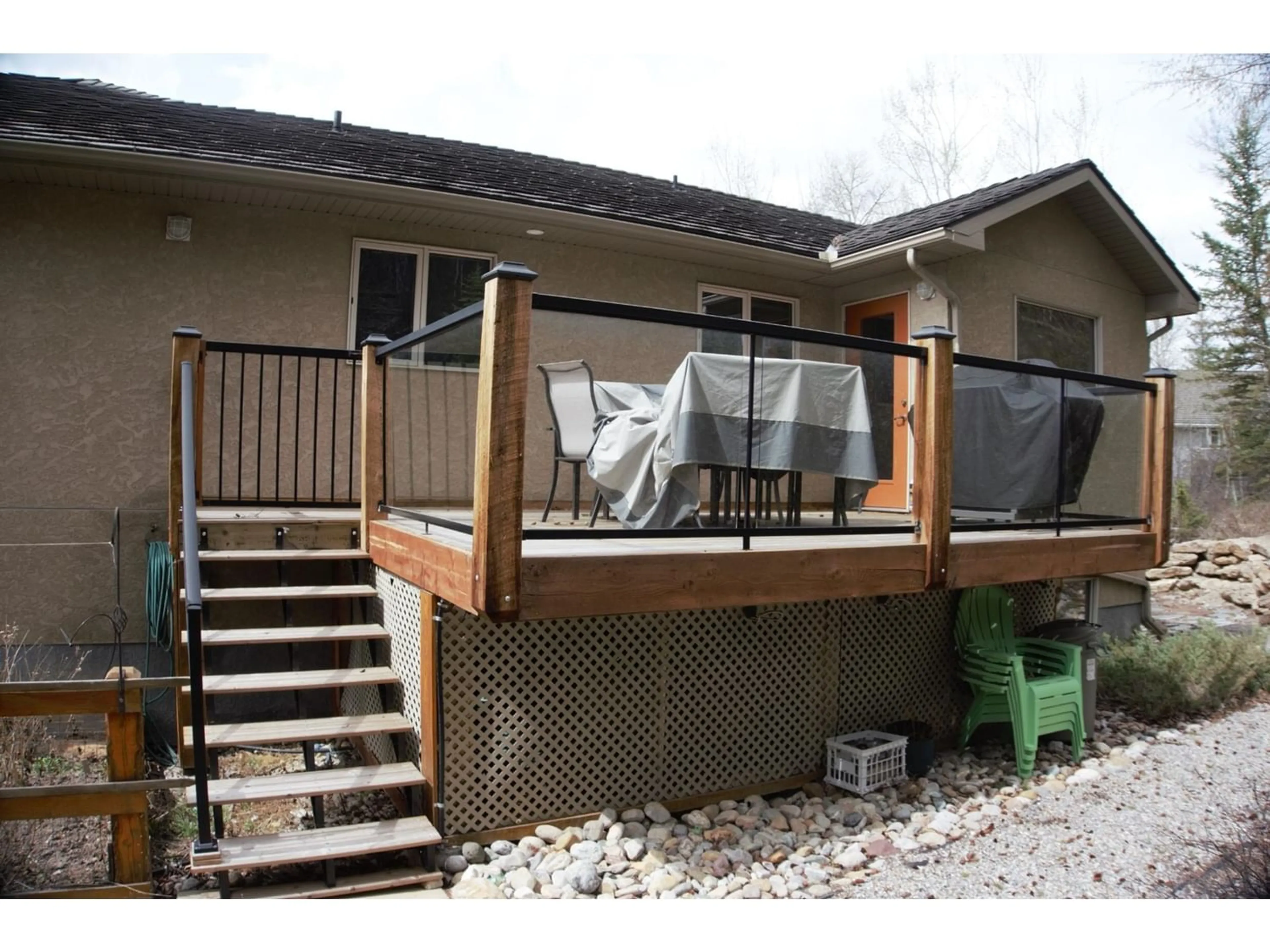 Frontside or backside of a home, the fenced backyard for 4937 ASPEN GROVE Place, Fairmont Hot Springs British Columbia V0B1L1