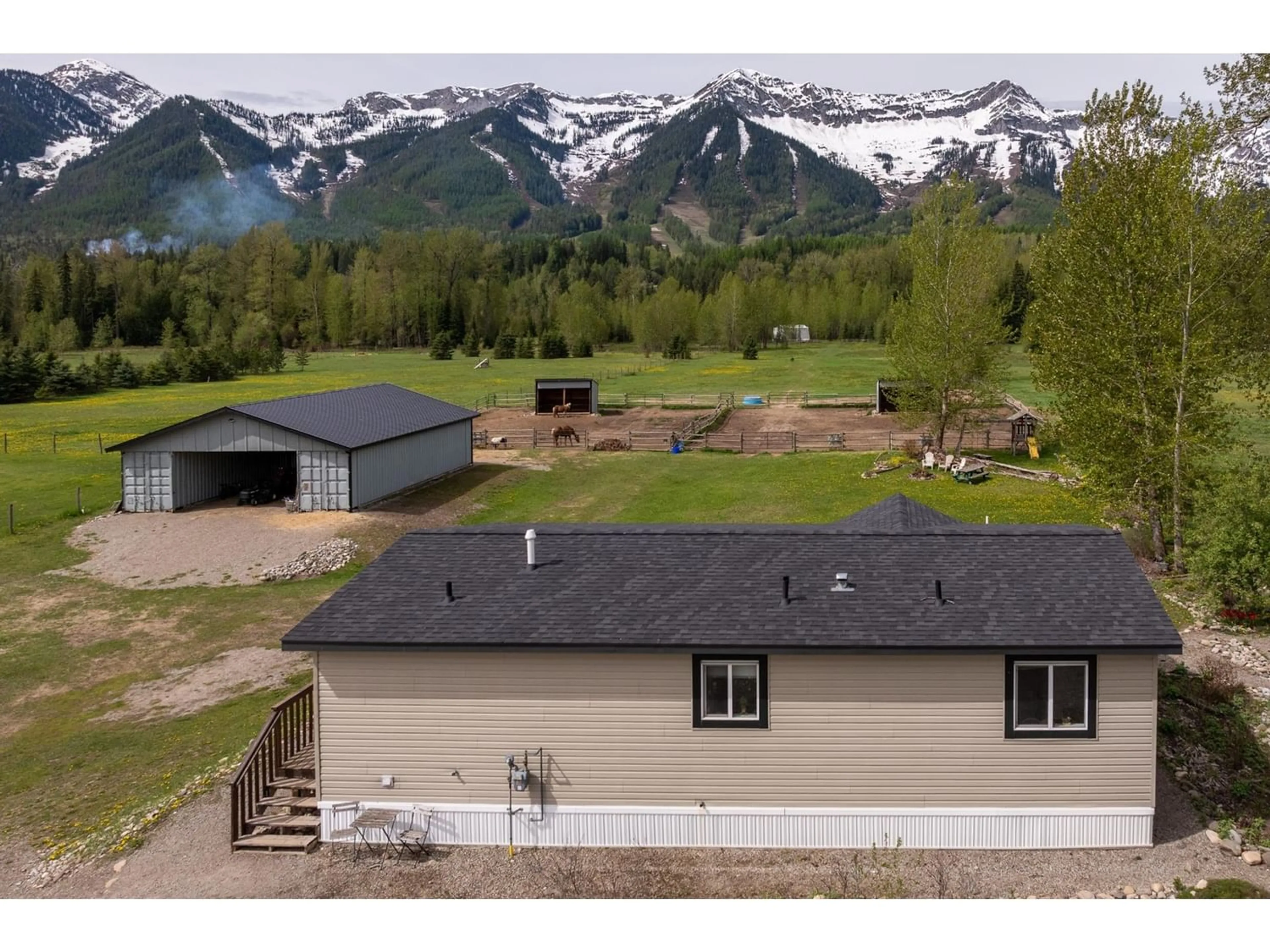 Frontside or backside of a home, the fenced backyard for 4103 HILL Road, Fernie British Columbia V0B1M4