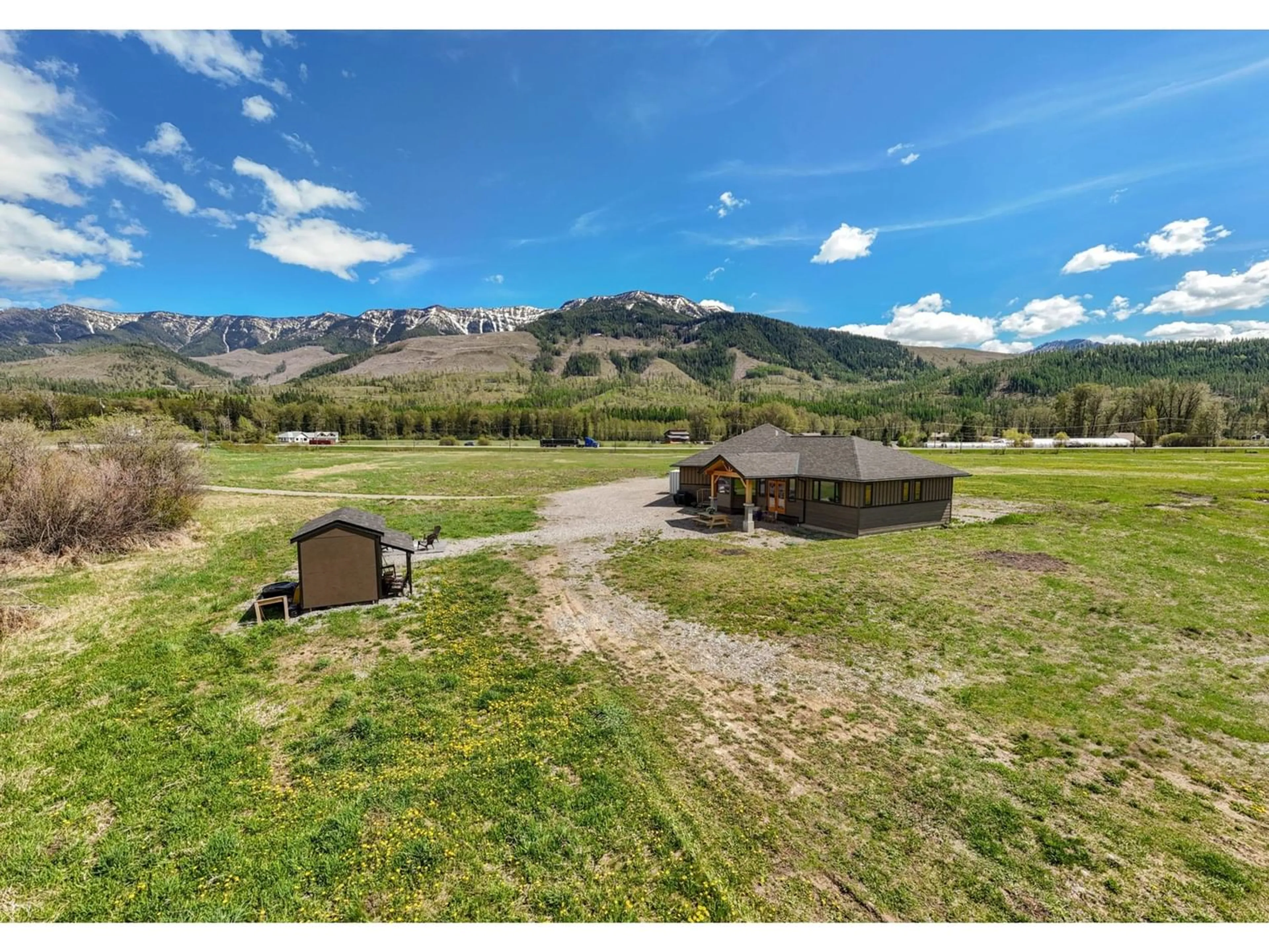 A pic from exterior of the house or condo, the fenced backyard for 6385 3 Highway, Fernie British Columbia V0B1M0