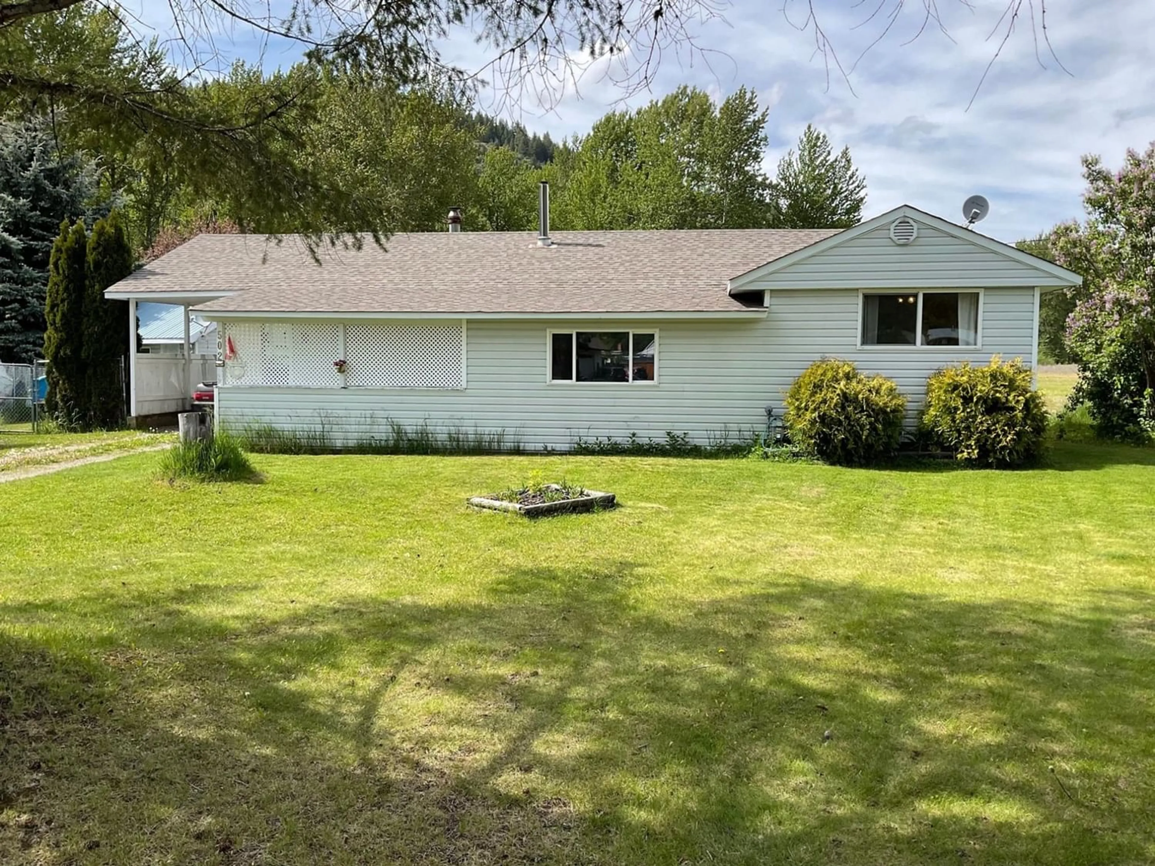 Frontside or backside of a home, the fenced backyard for 502 WOODGREEN Crescent, Greenwood British Columbia V0H1J0