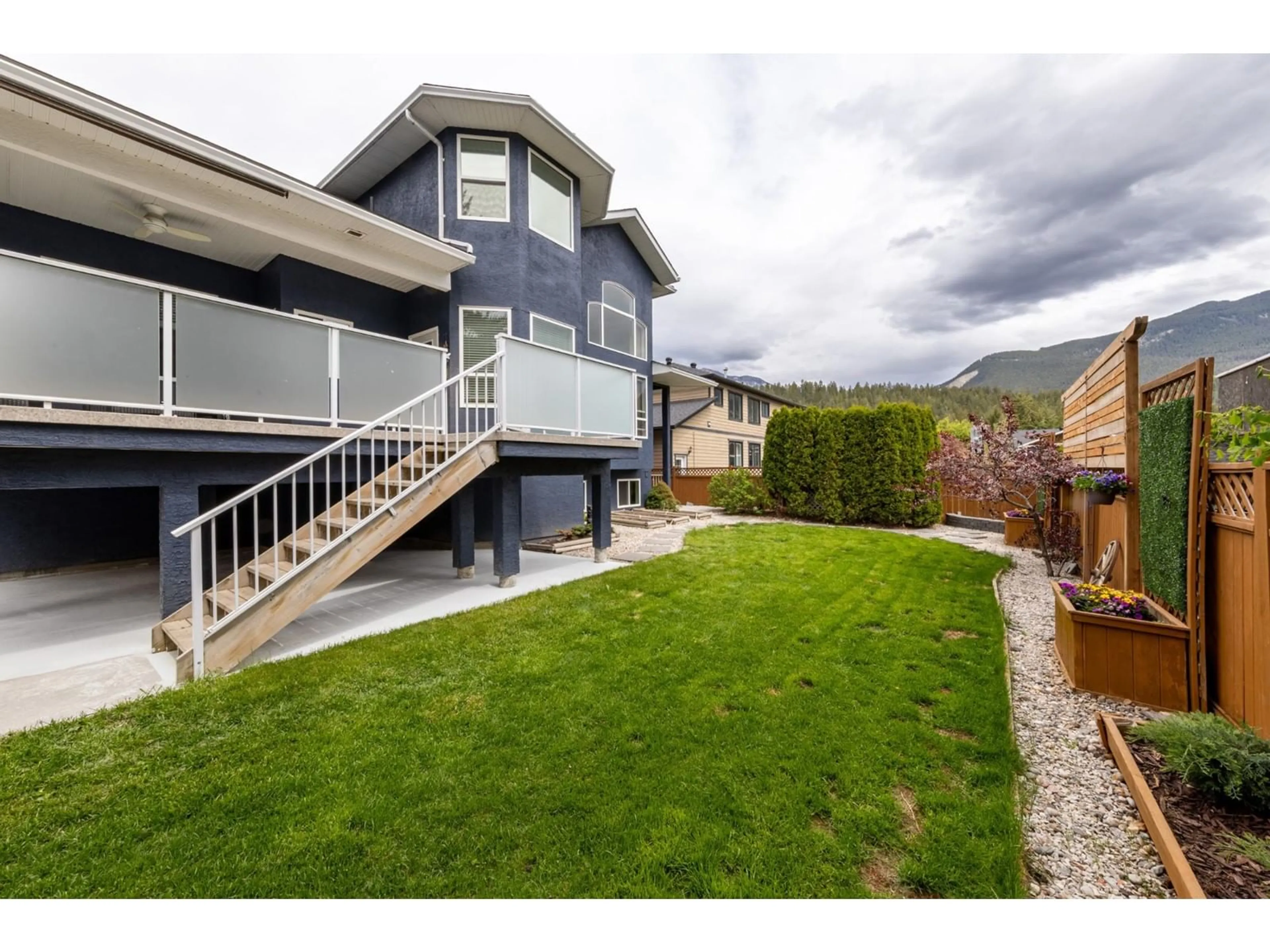 Frontside or backside of a home, the fenced backyard for 1504 POPLAR Street, Golden British Columbia V0A1H6