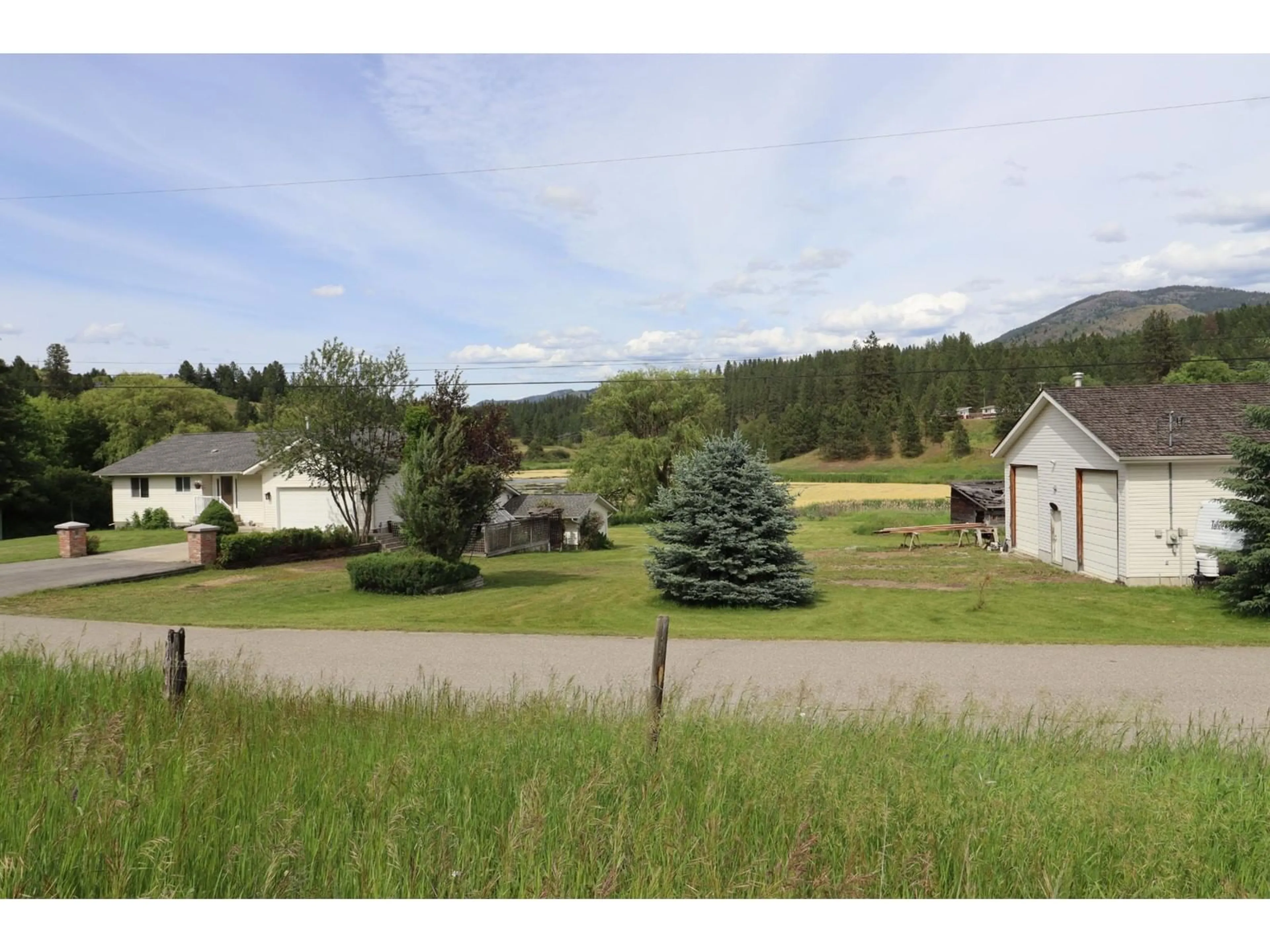 Frontside or backside of a home, the fenced backyard for 3185 WARD Road, Grand Forks British Columbia V0H1H2