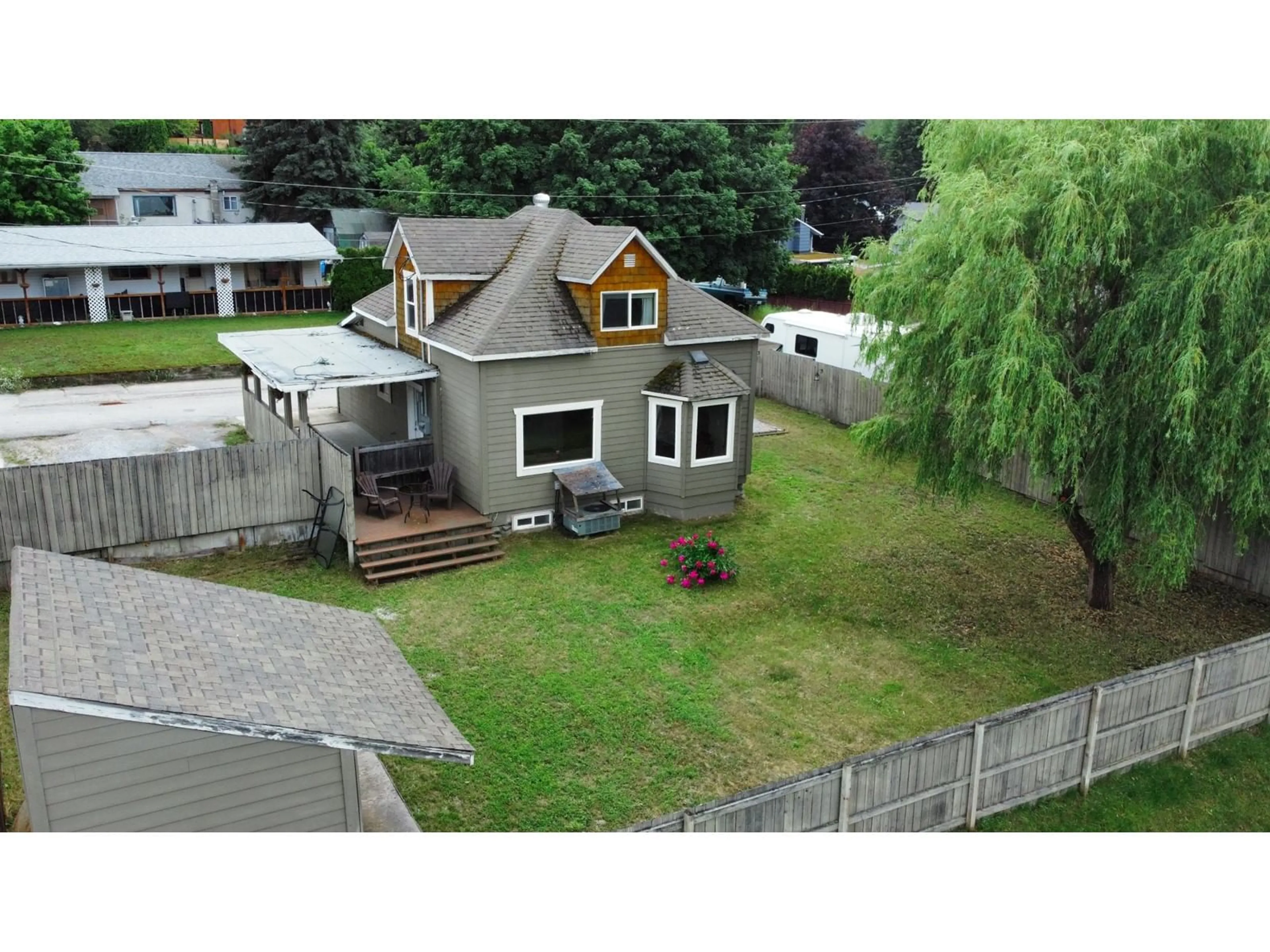 Frontside or backside of a home, the fenced backyard for 1887 KOOTENAY Lane, Fruitvale British Columbia V0G1L0