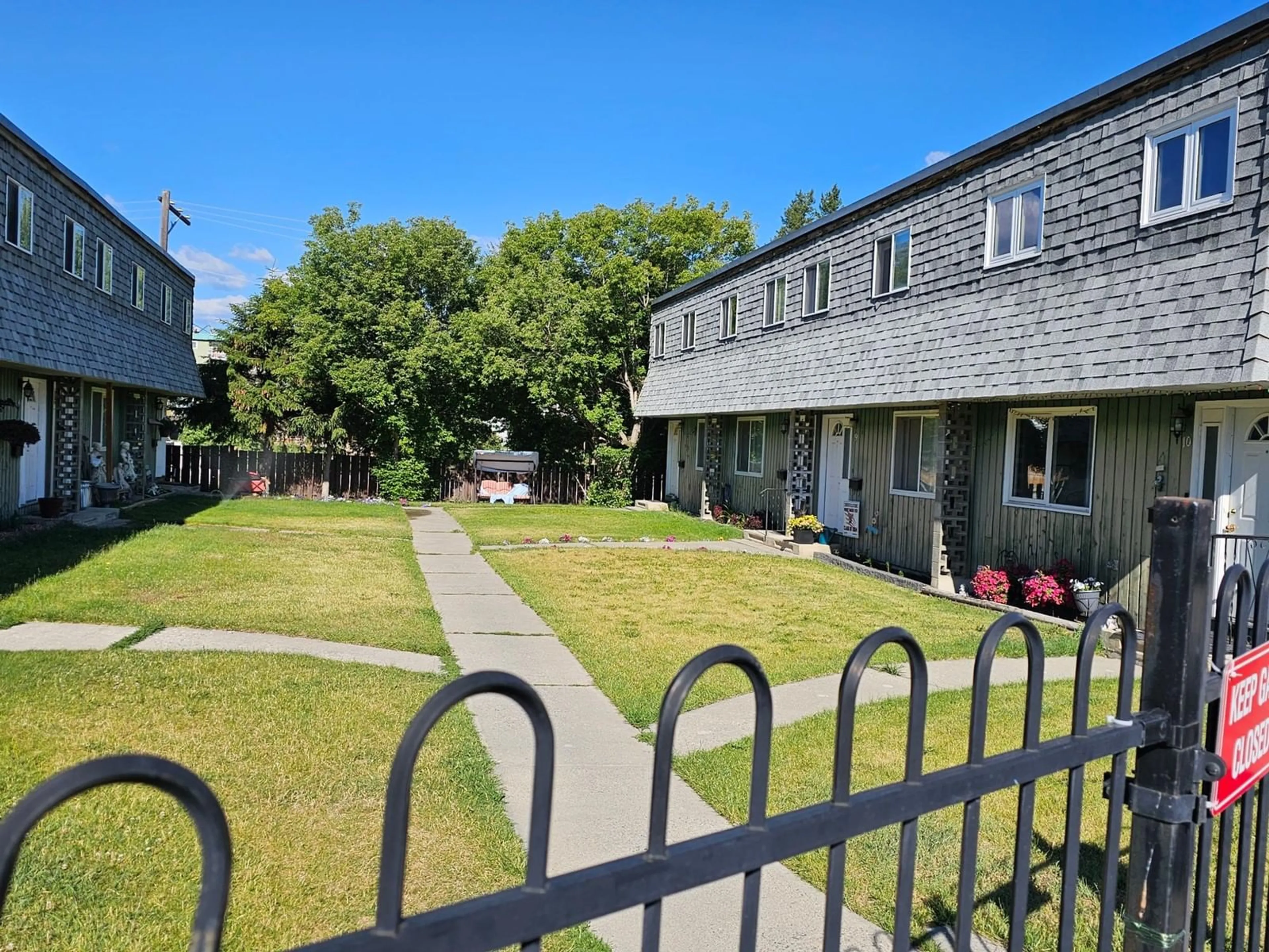 A pic from exterior of the house or condo, the fenced backyard for 109 23RD  S Avenue Unit# 9, Cranbrook British Columbia V1C4P1