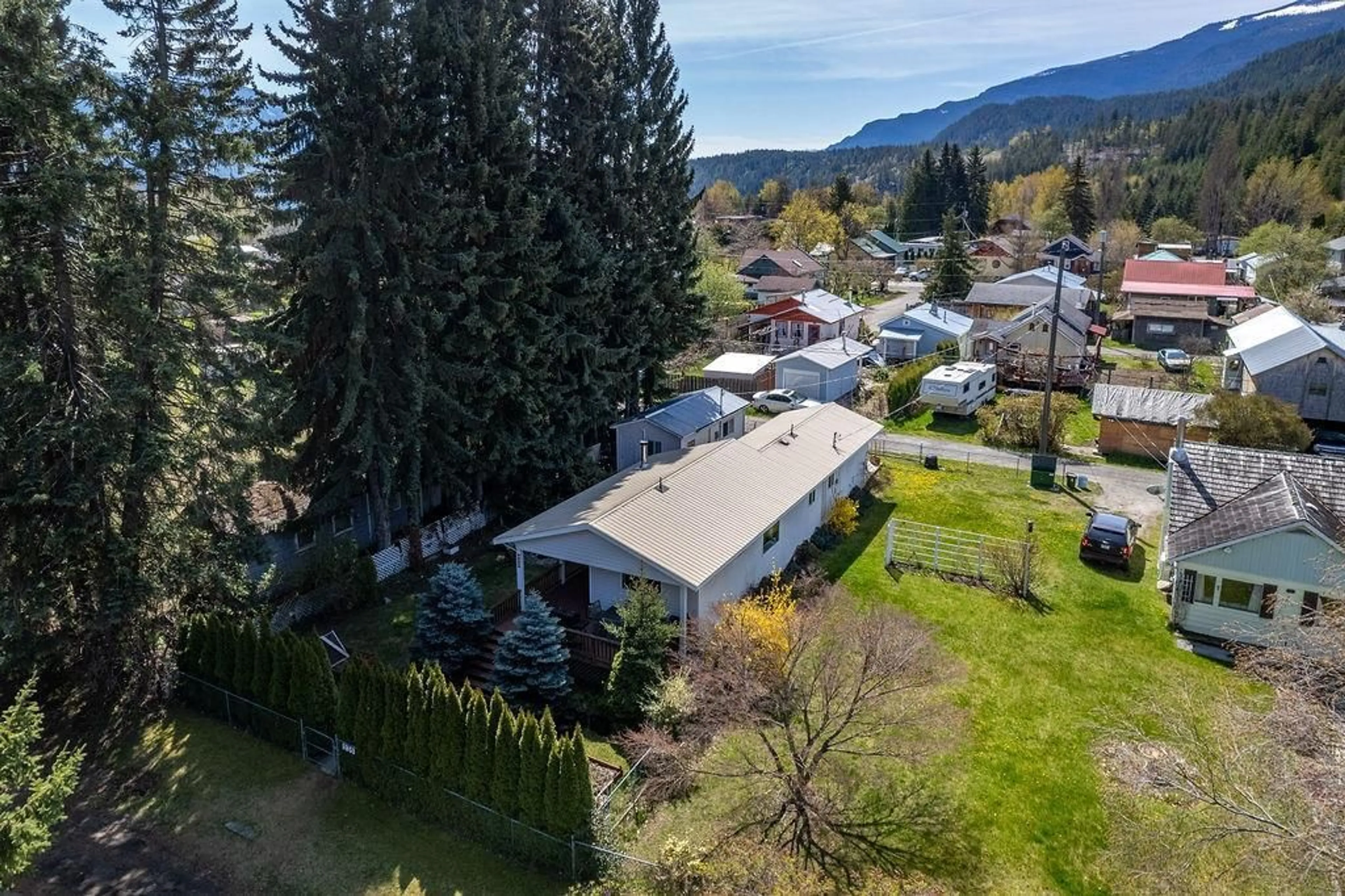 Frontside or backside of a home, the fenced backyard for 235 B Avenue, Kaslo British Columbia V0G1M0