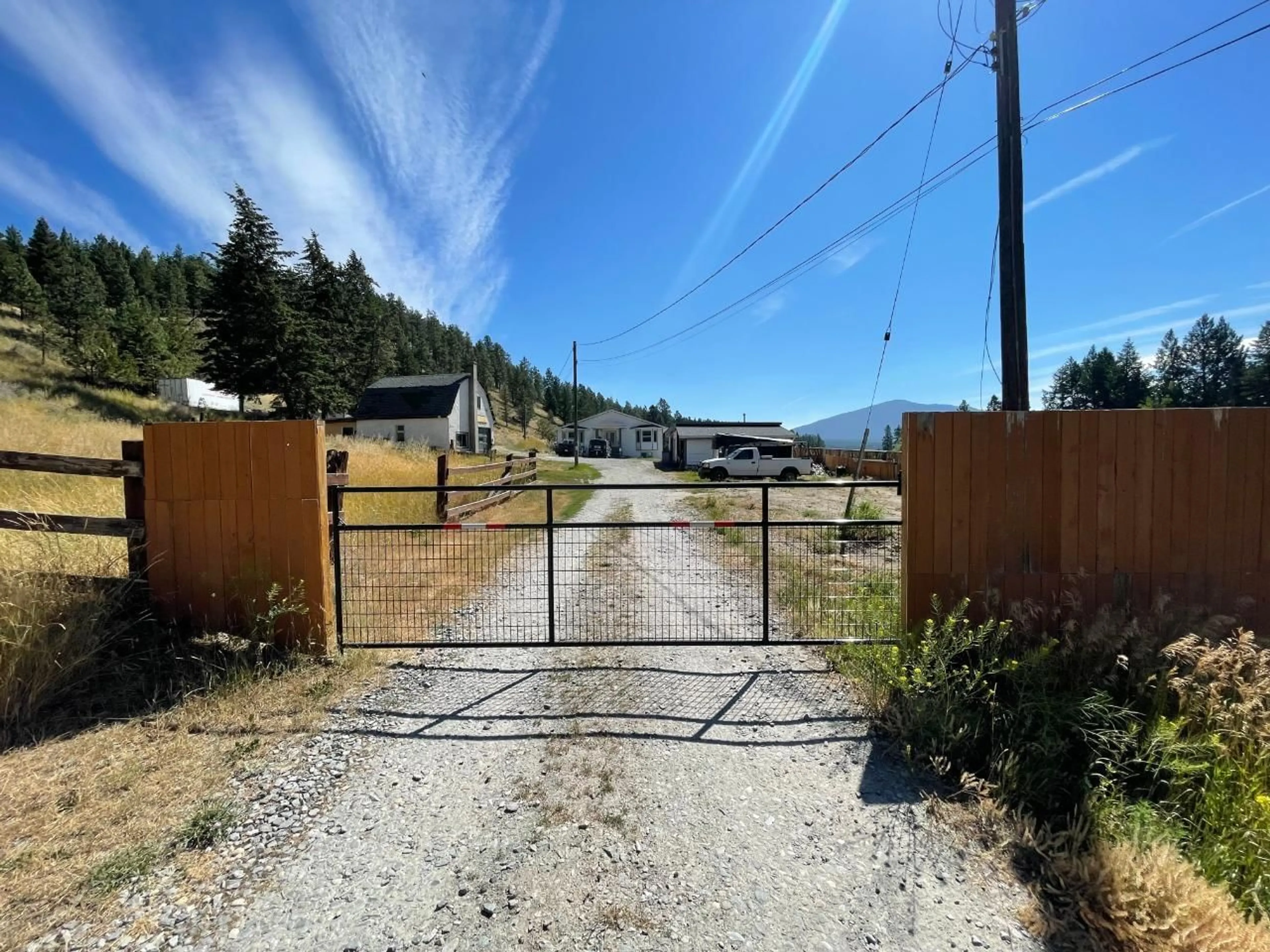 Frontside or backside of a home, the fenced backyard for 1014 KING Street, Cranbrook British Columbia V1C6S6