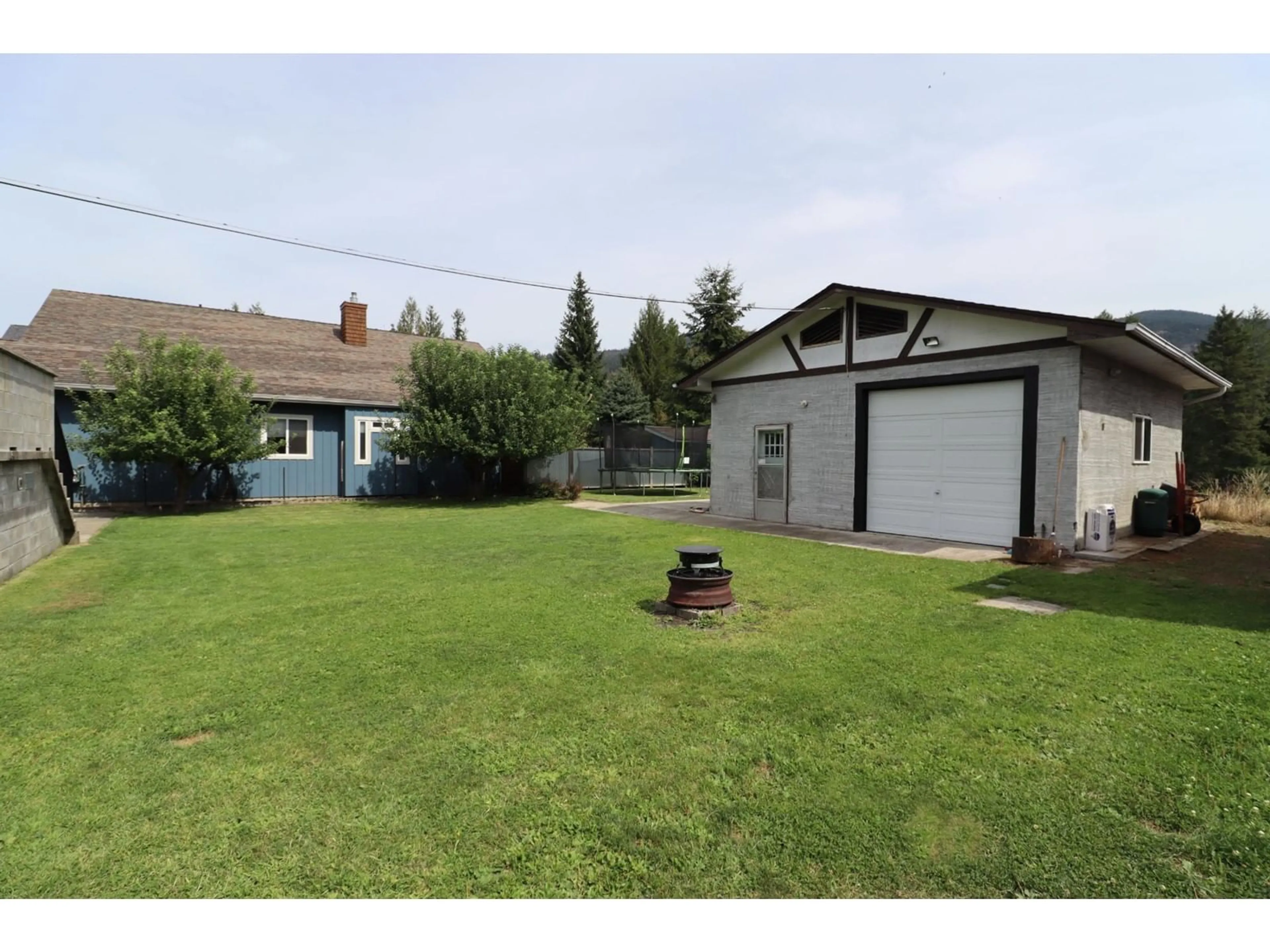 Frontside or backside of a home, the fenced backyard for 40 CHASE Road, Christina Lake British Columbia V0H1E0