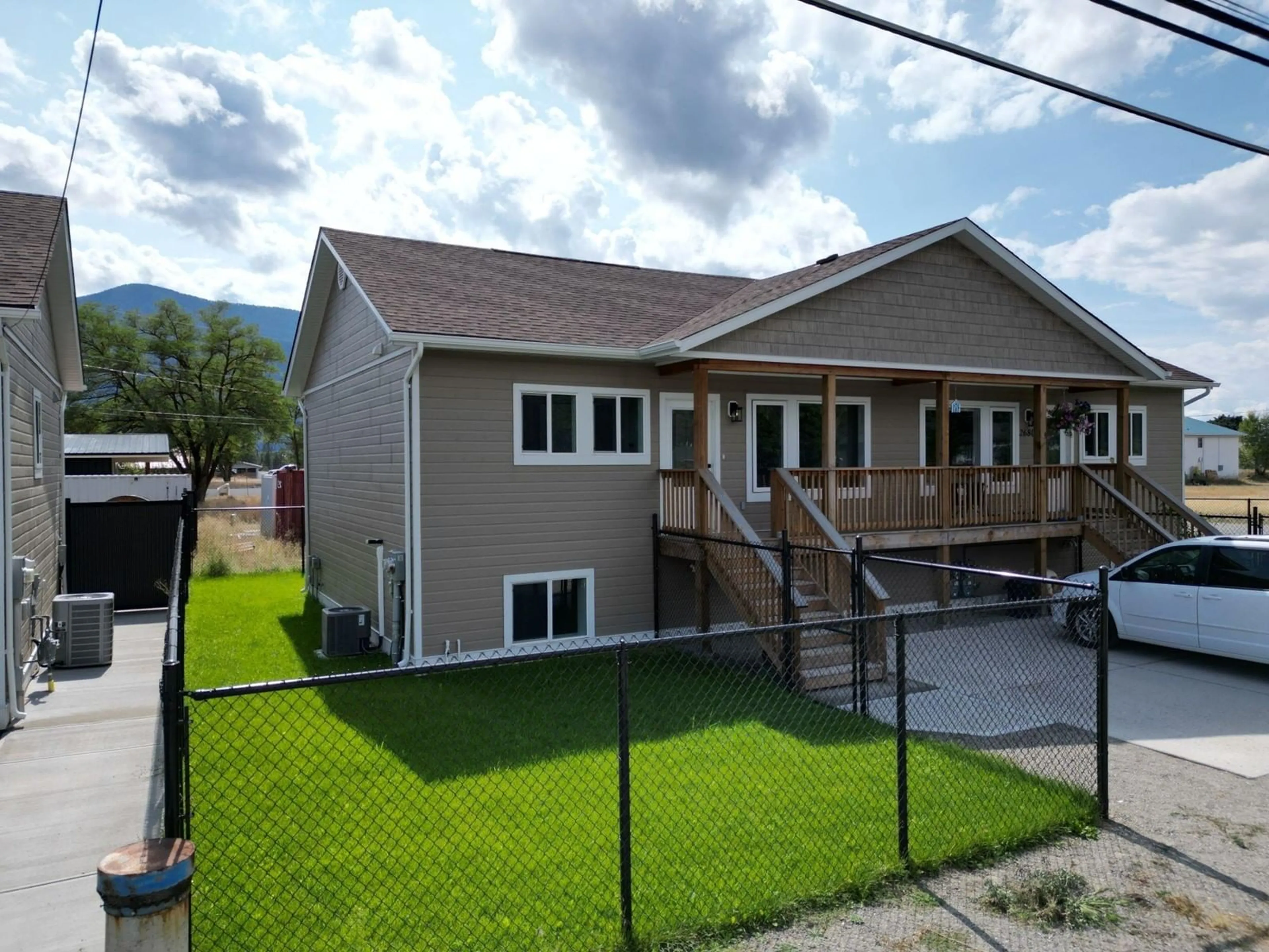 Frontside or backside of a home, the fenced backyard for 2680 75TH Avenue Unit# A, Grand Forks British Columbia V0H1H2