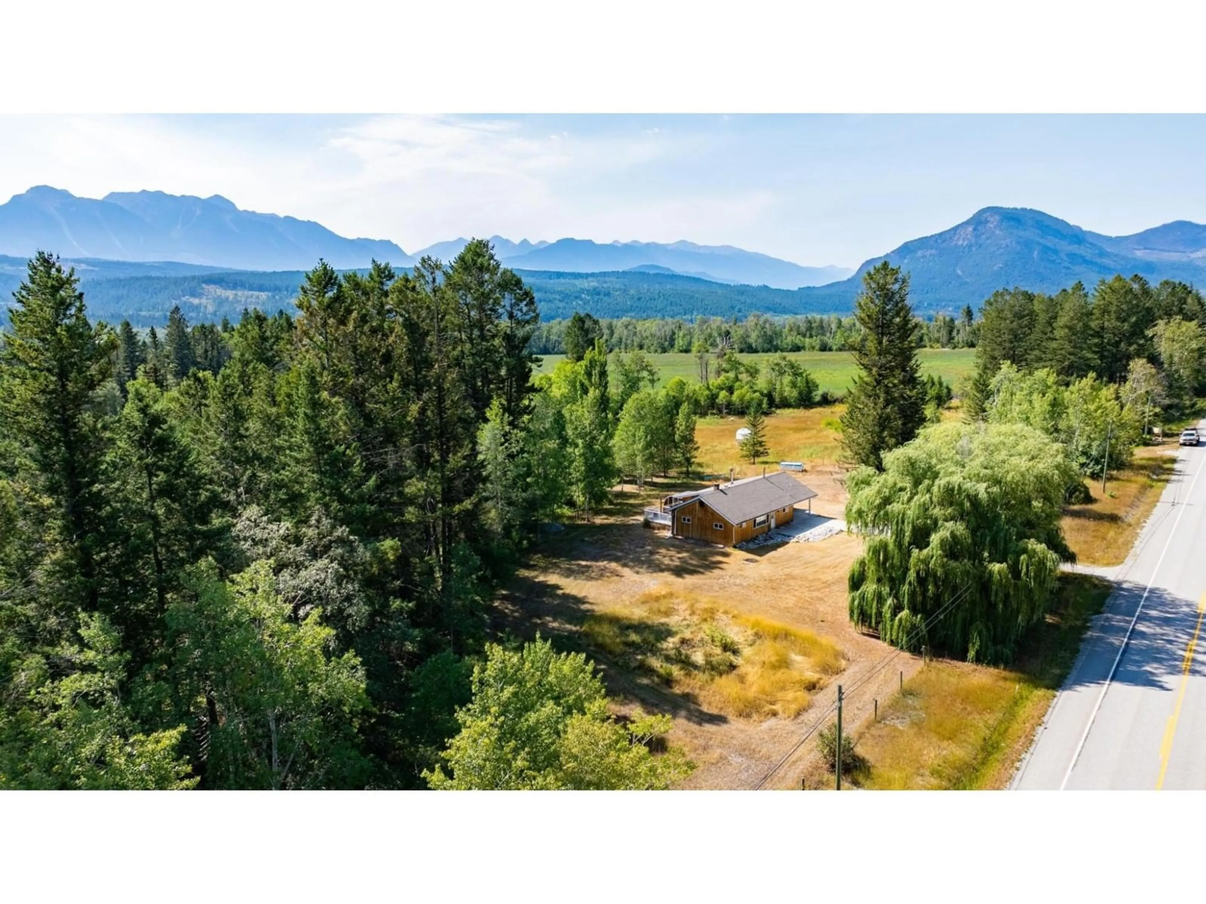 Frontside or backside of a home, the fenced backyard for 1359 95 Highway, Spillimacheen British Columbia V0A1P0