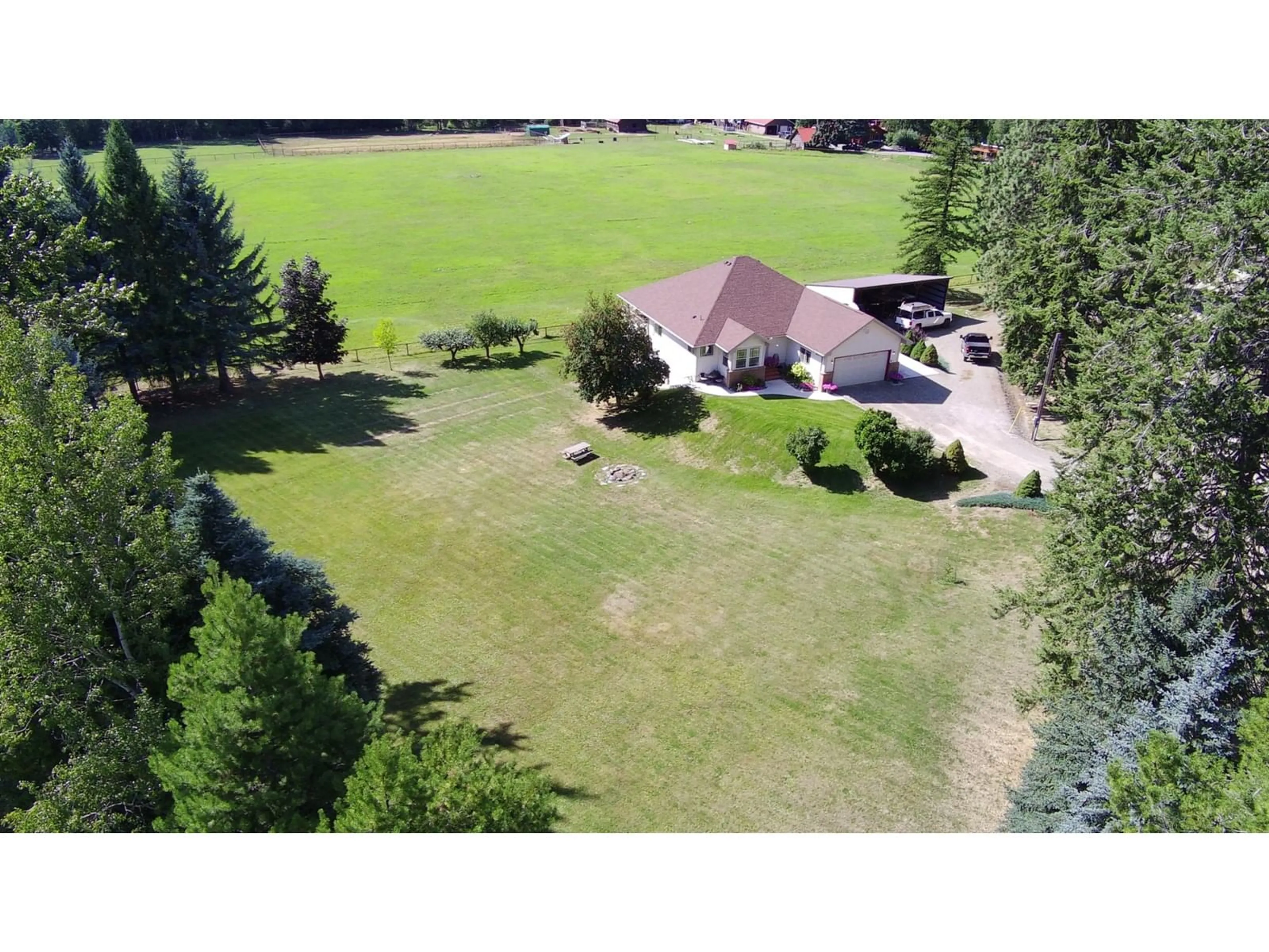 Frontside or backside of a home, the fenced backyard for 221 ARROW CREEK  E Road, Arrow Creek British Columbia V0B1G1